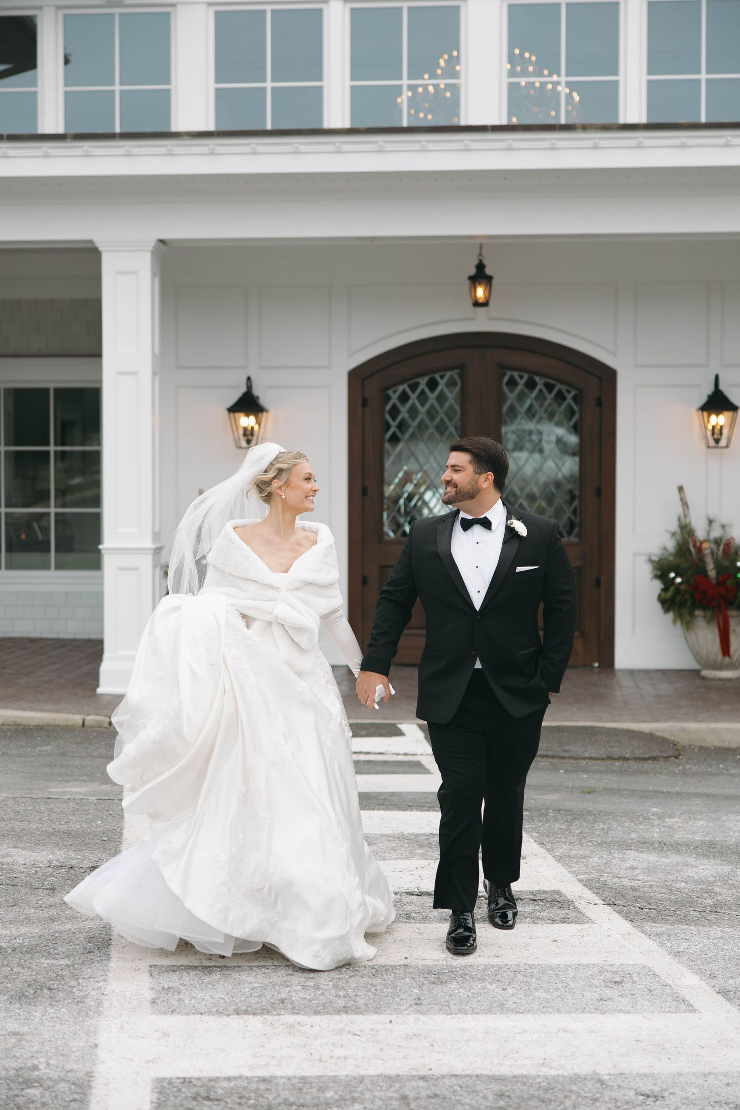 The bride's dress creates beautiful movement as she spins on the venue's stone courtyard.