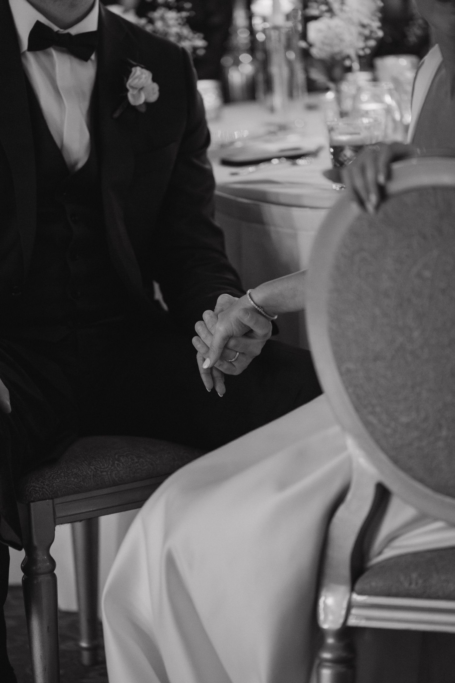 Close-up details of formal attire and seating arrangements at an elegant event.