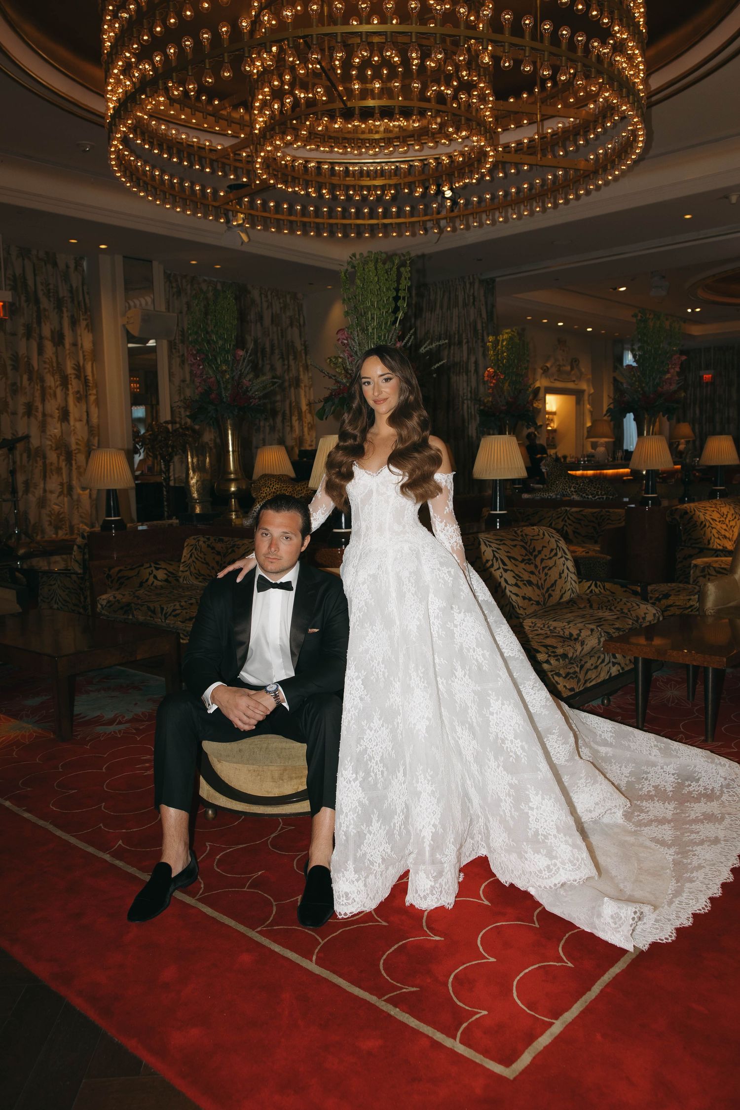 Elegant hotel lobby setting with ornate chandelier and luxurious decor.