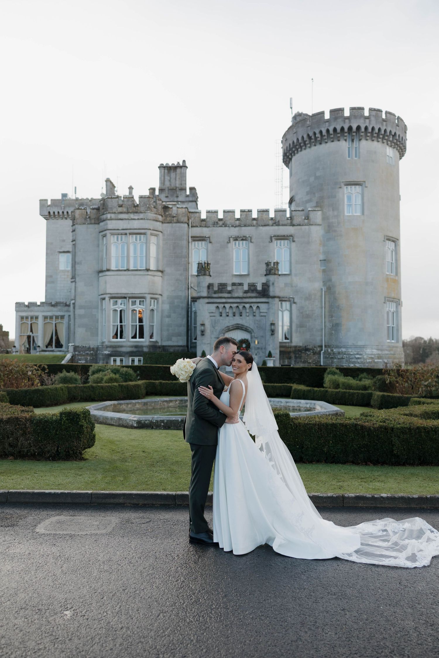 Majestic stone castle provides dramatic backdrop for wedding photography.