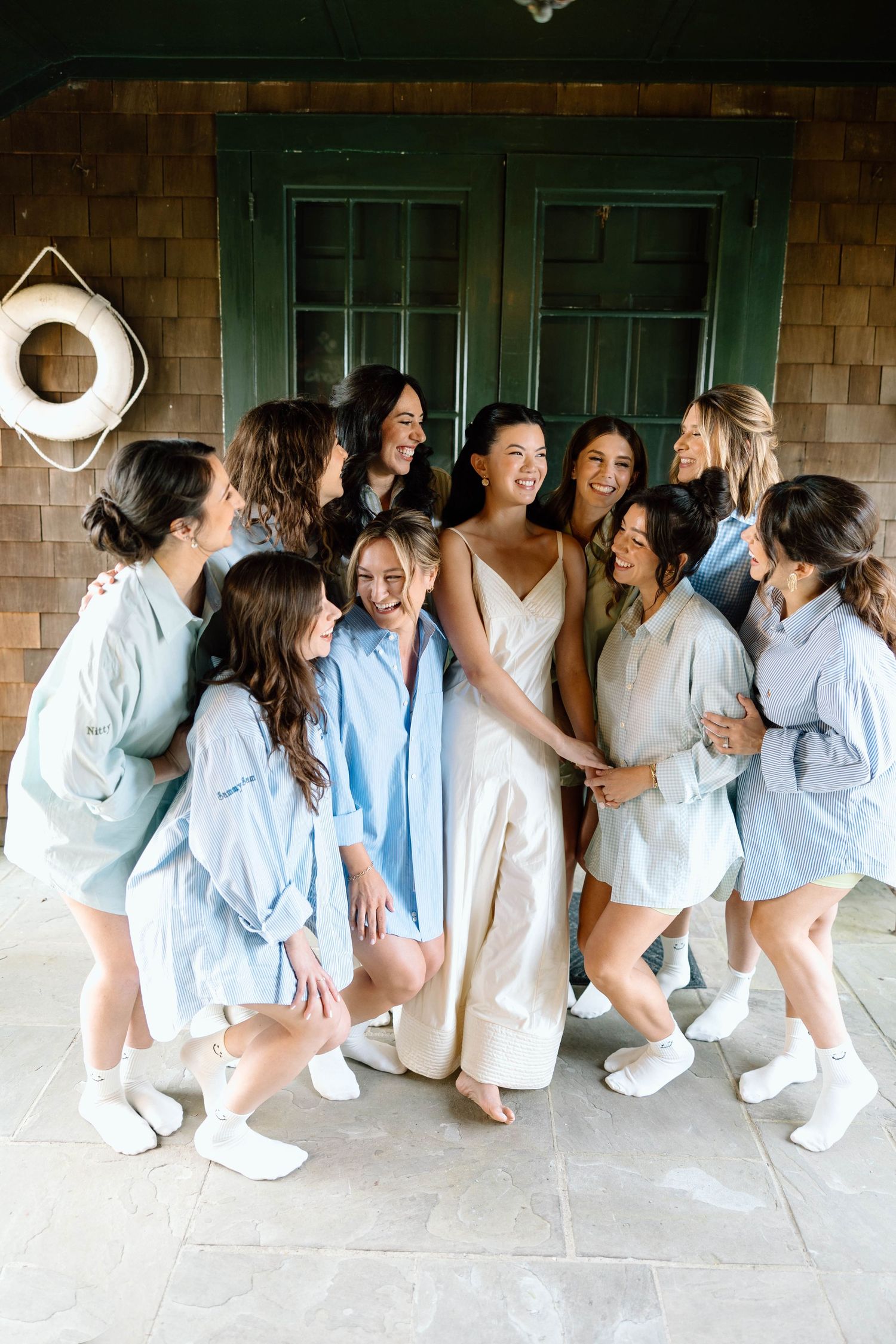 Group wearing matching light blue outfits sitting together in casual poses.