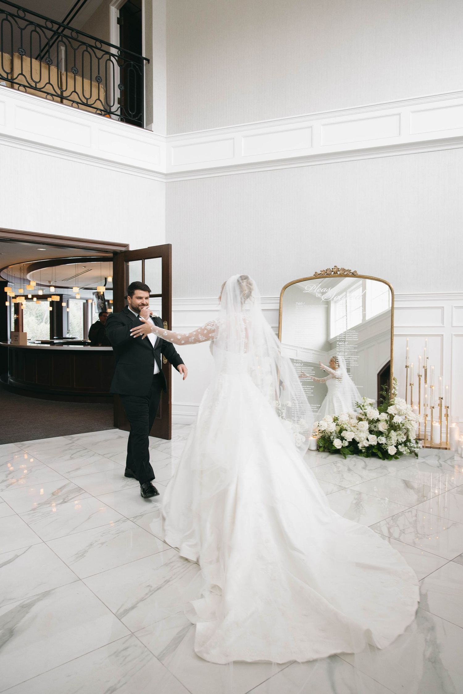 A series of candid wedding photos showing the couple's first look in a bright modern venue.