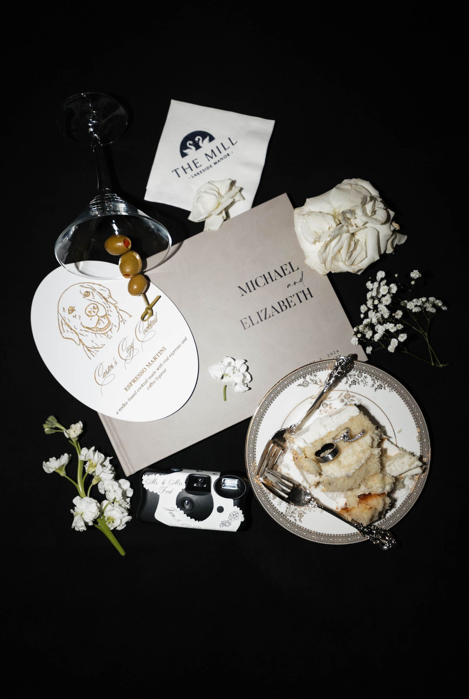 Wedding place cards and table settings with elegant white floral decorations.