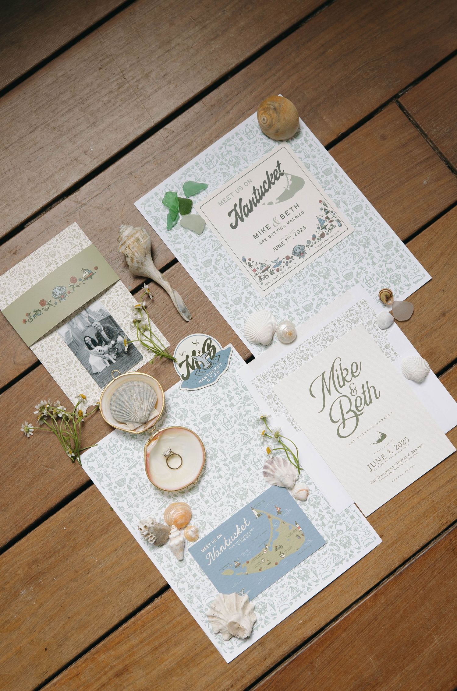 Vintage-inspired wedding invitation suite with seashells and Nantucket theme on wooden background.