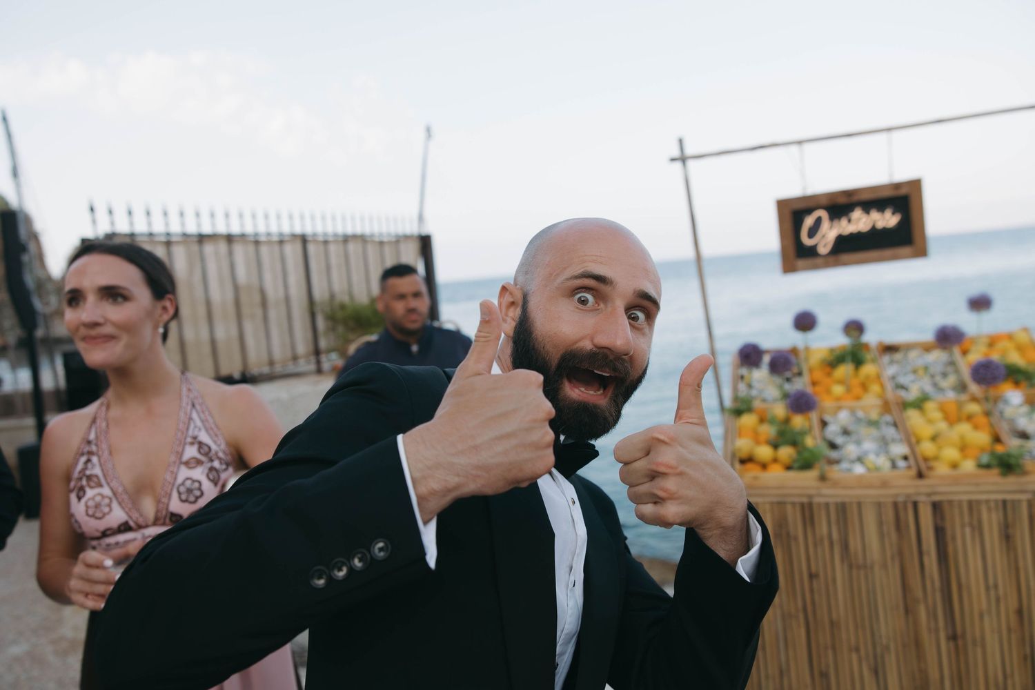 Elegant outdoor wedding reception setup with decorative elements and ocean views.