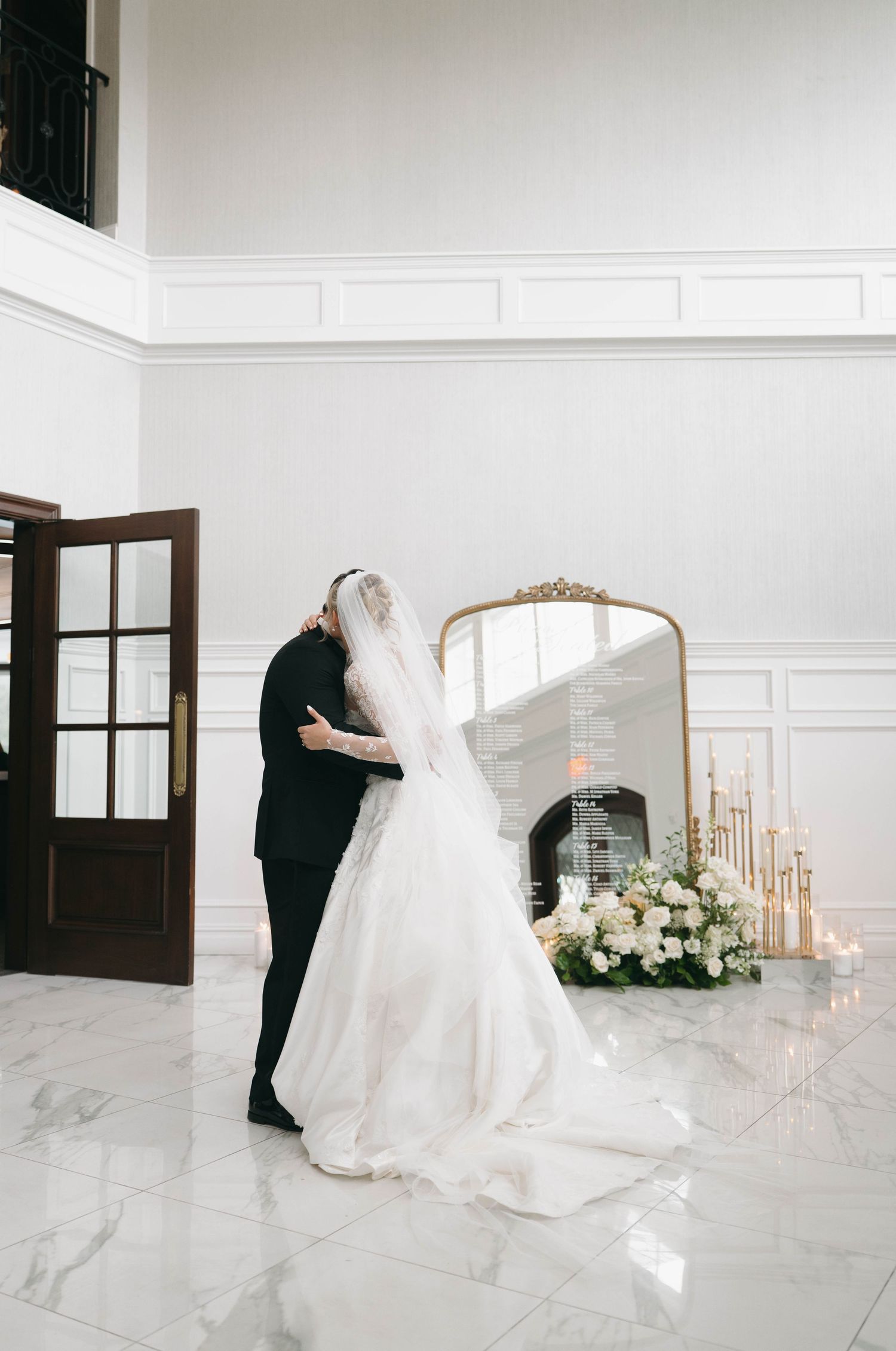 Wedding venue with marble floors, white walls and romantic candle decorations.