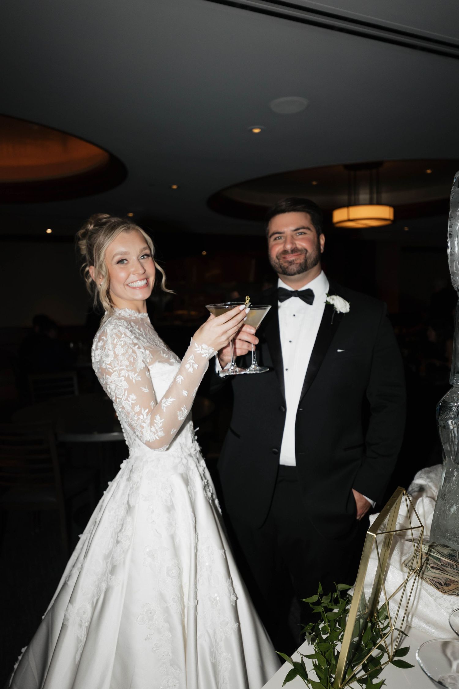 Wedding celebration with formal attire and elegant table settings at an evening reception.