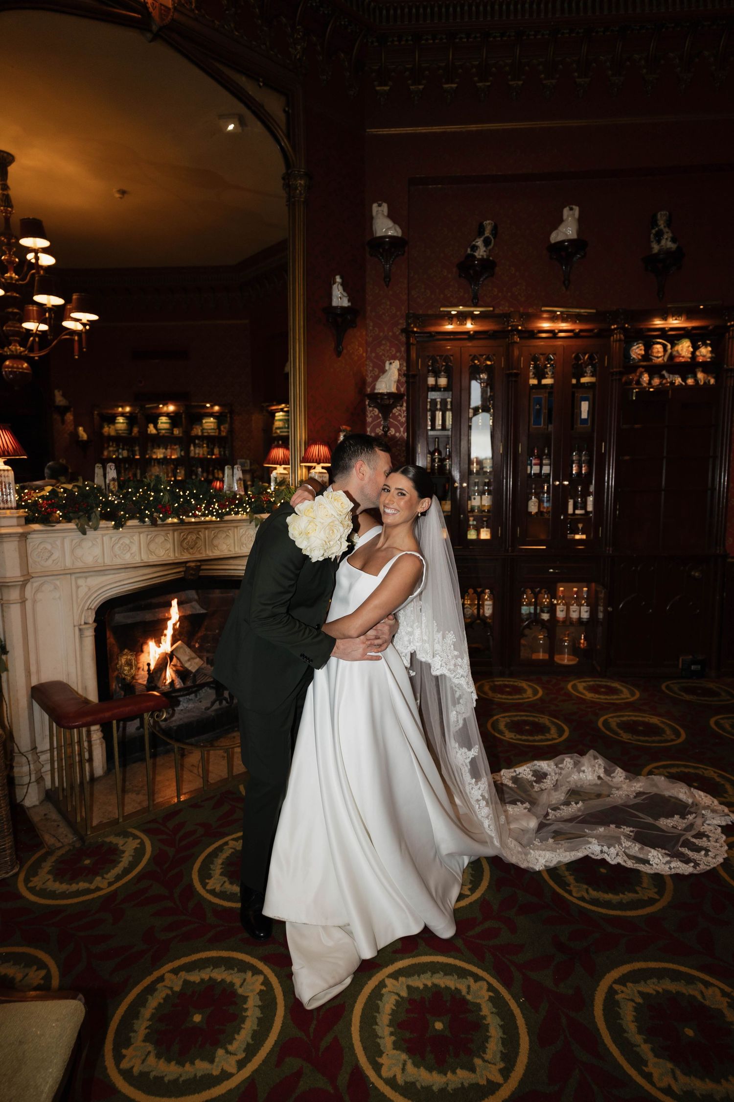 A romantic dance sequence in a dimly lit room with elegant decor and a long flowing white dress.