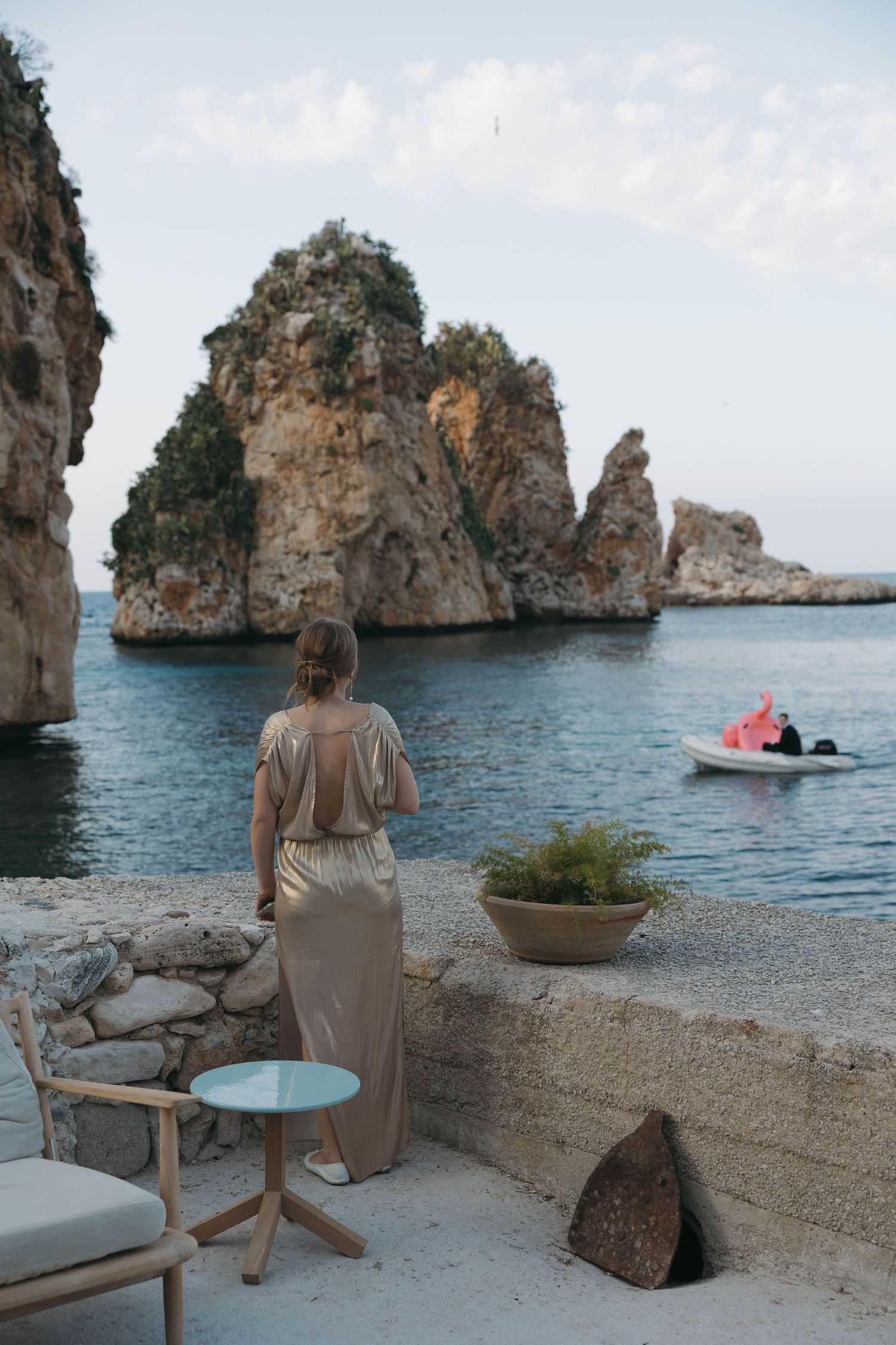 Scenic coastal view with rocky cliffs and turquoise waters along a Mediterranean beach setting.