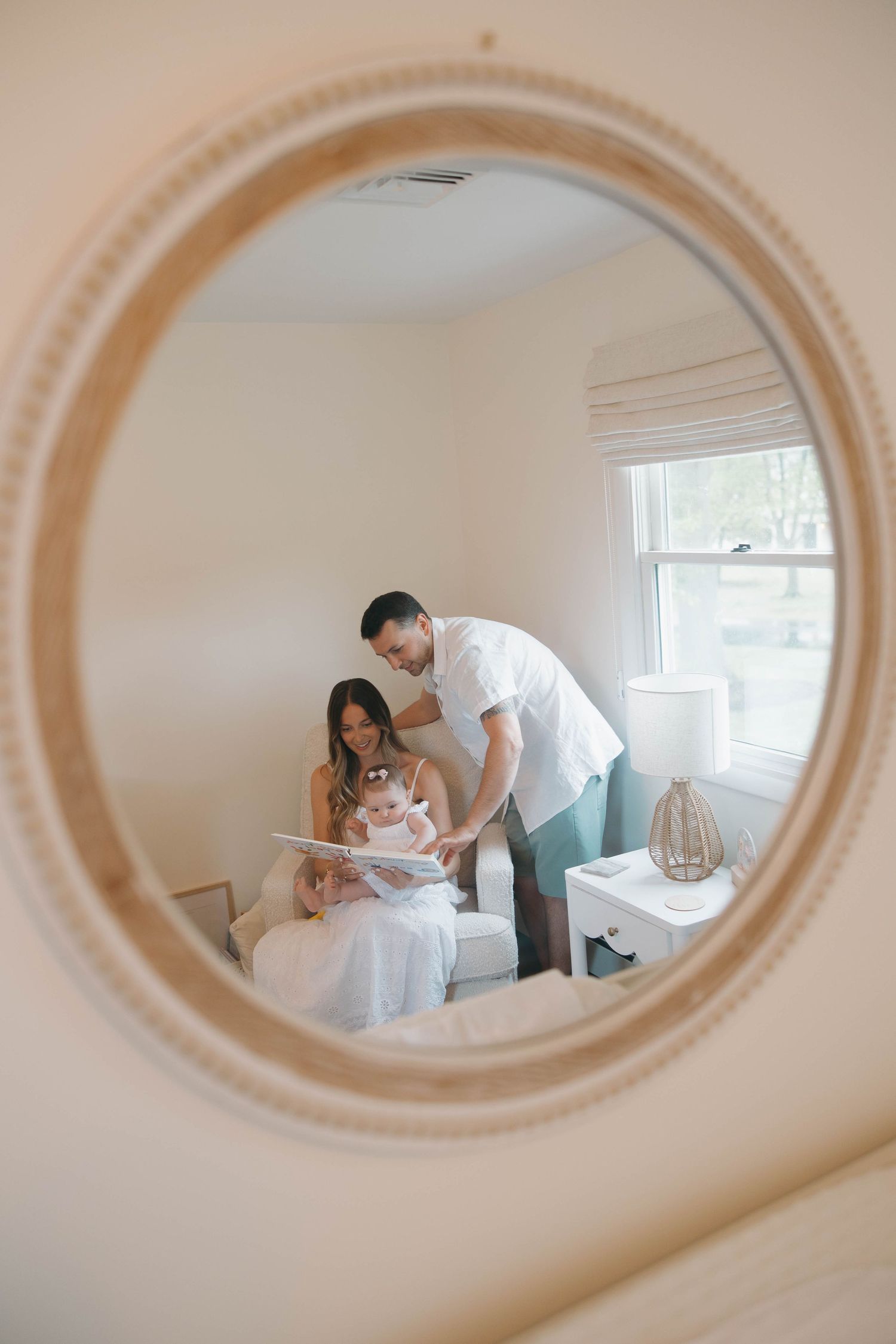A sequence of five oval-framed mirror reflections showing a romantic moment between two people in a light-filled room.