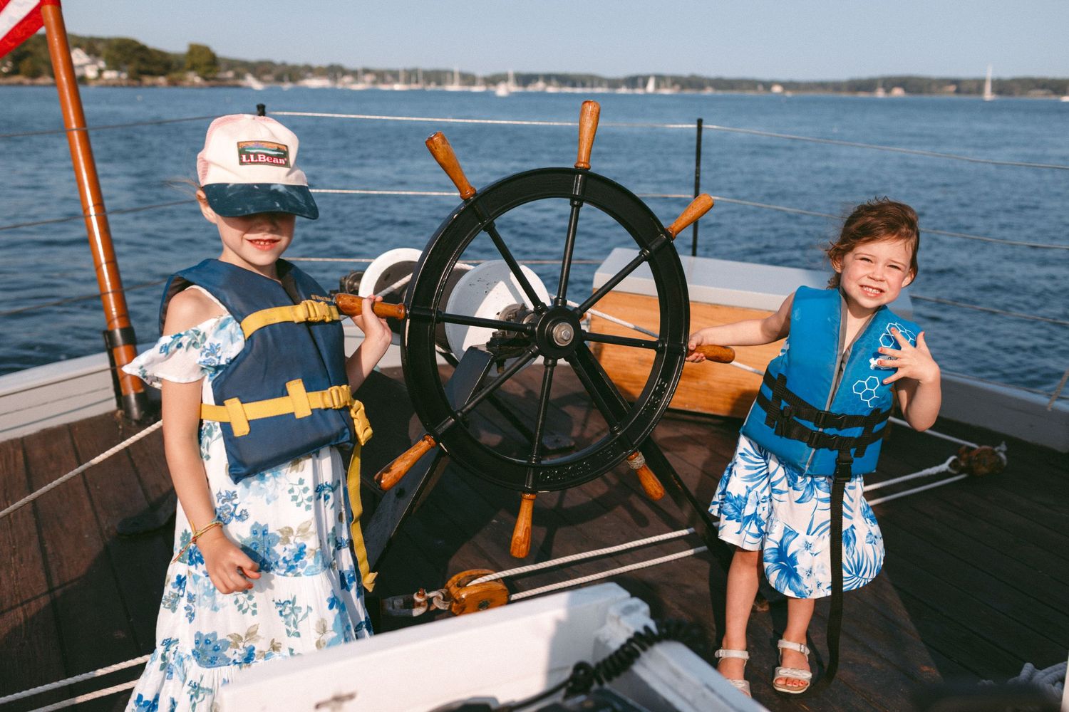 Children explore the helm of a boat during a wedding celebration.