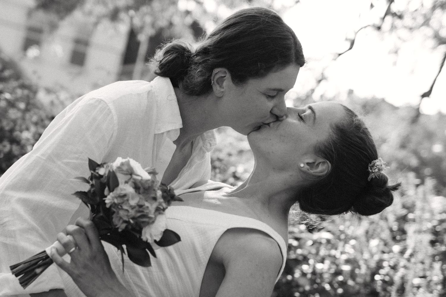 A romantic black and white portrait of a couple sharing an intimate moment.