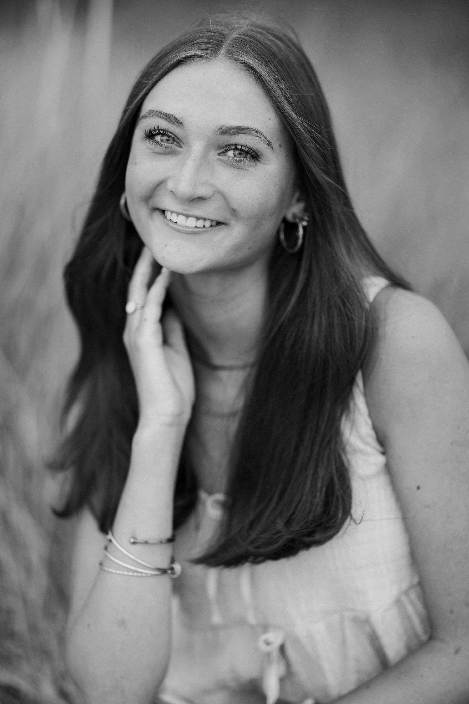 Black and white portrait series showing casual poses and natural expressions.