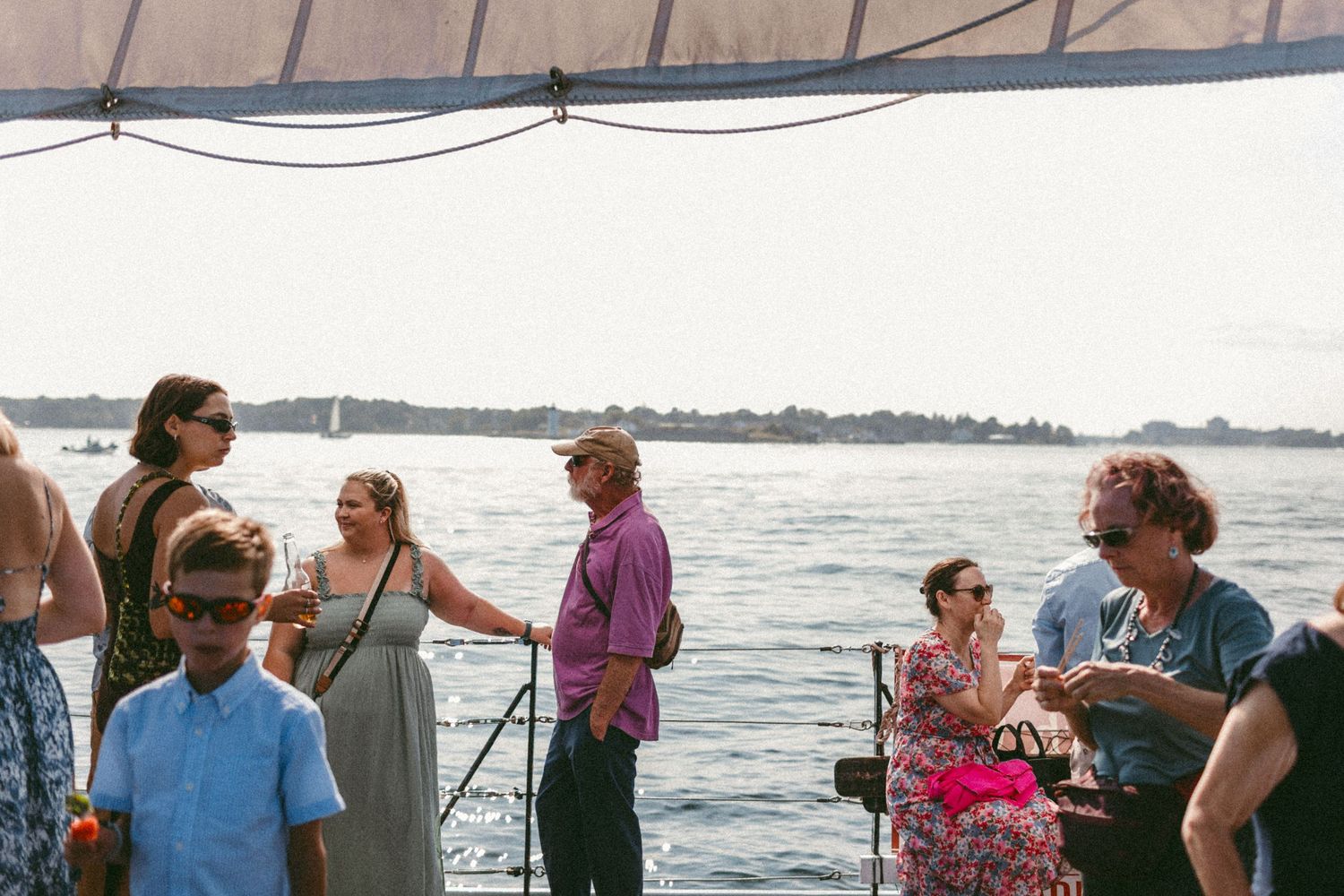 Group of people gathered on a boat deck during a celebration at sea.