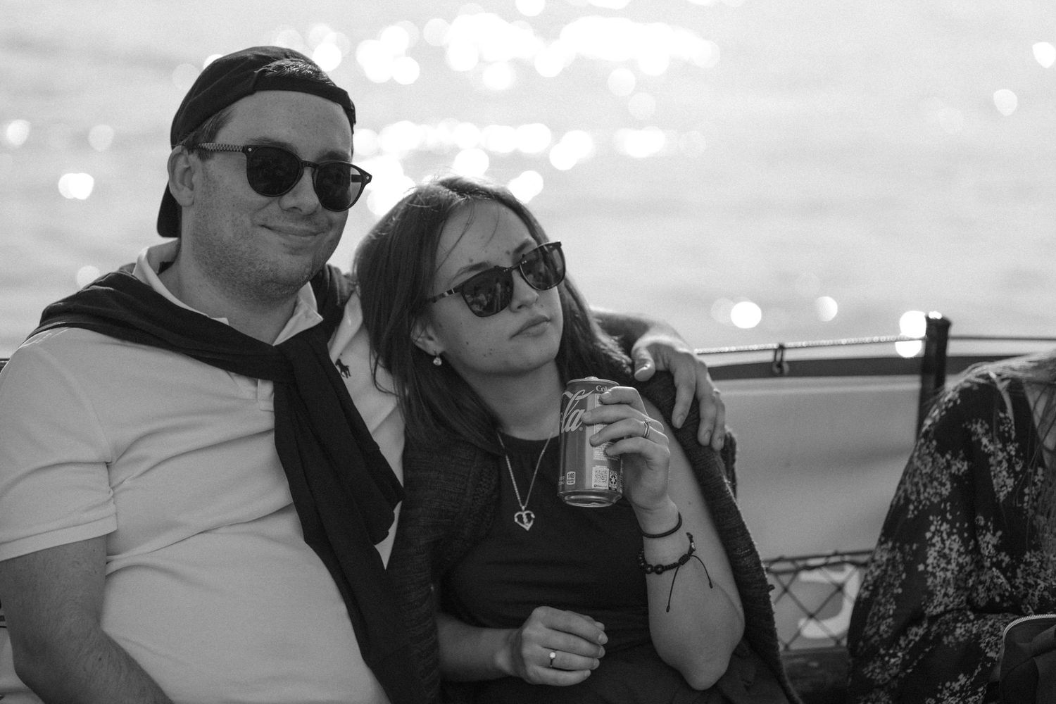 Guests enjoying drinks and conversation at a waterfront celebration.