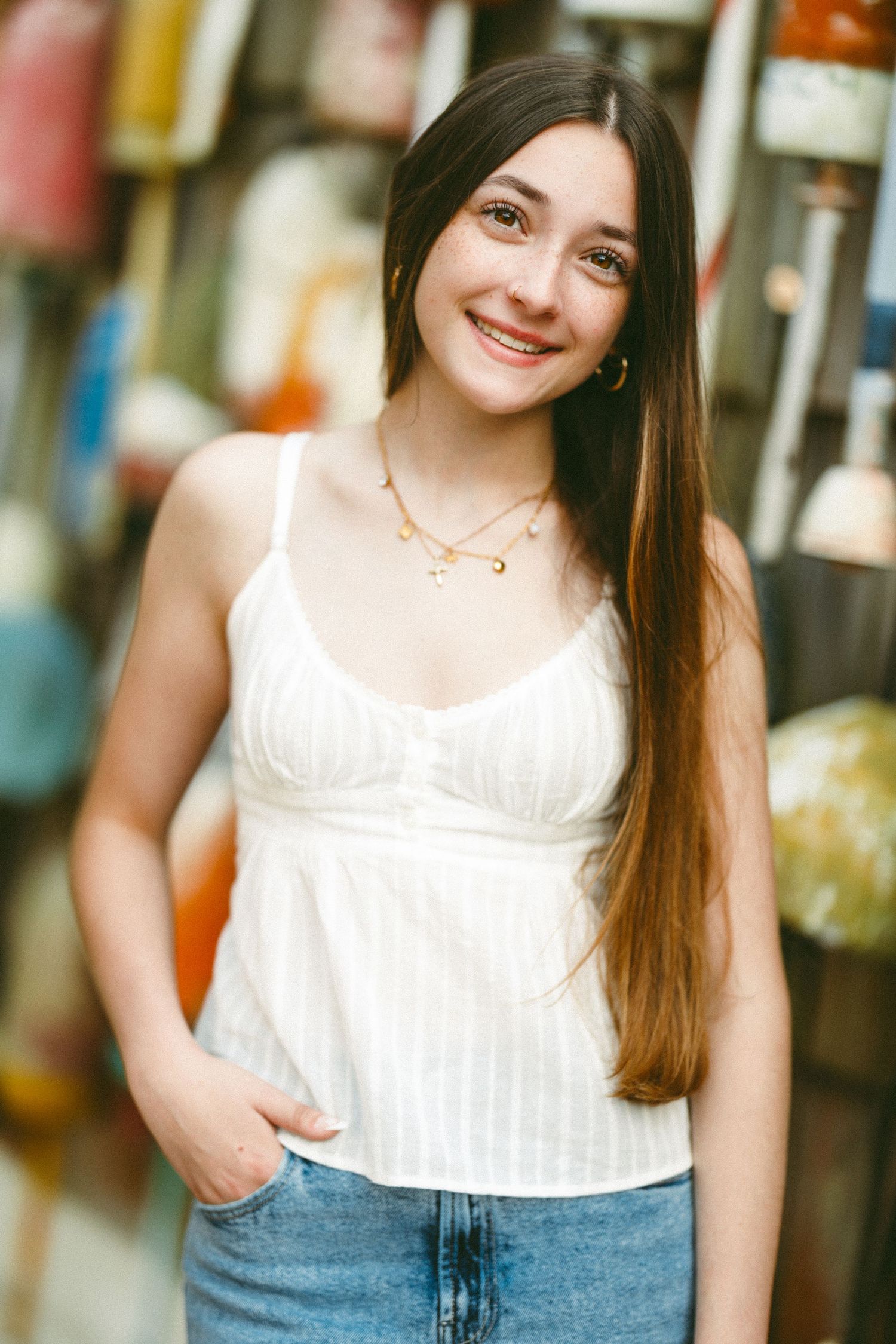 Urban portrait series showing person in white top and denim against colorful background.