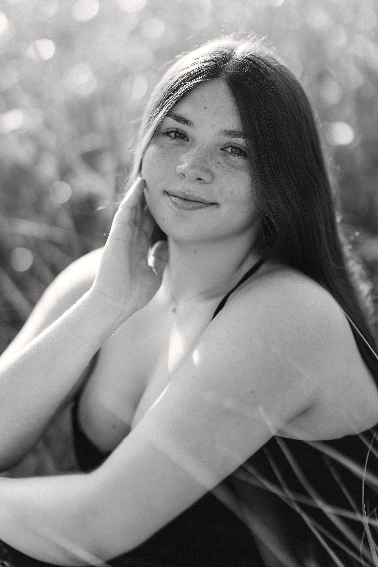 Black and white portrait with soft bokeh lighting effects.