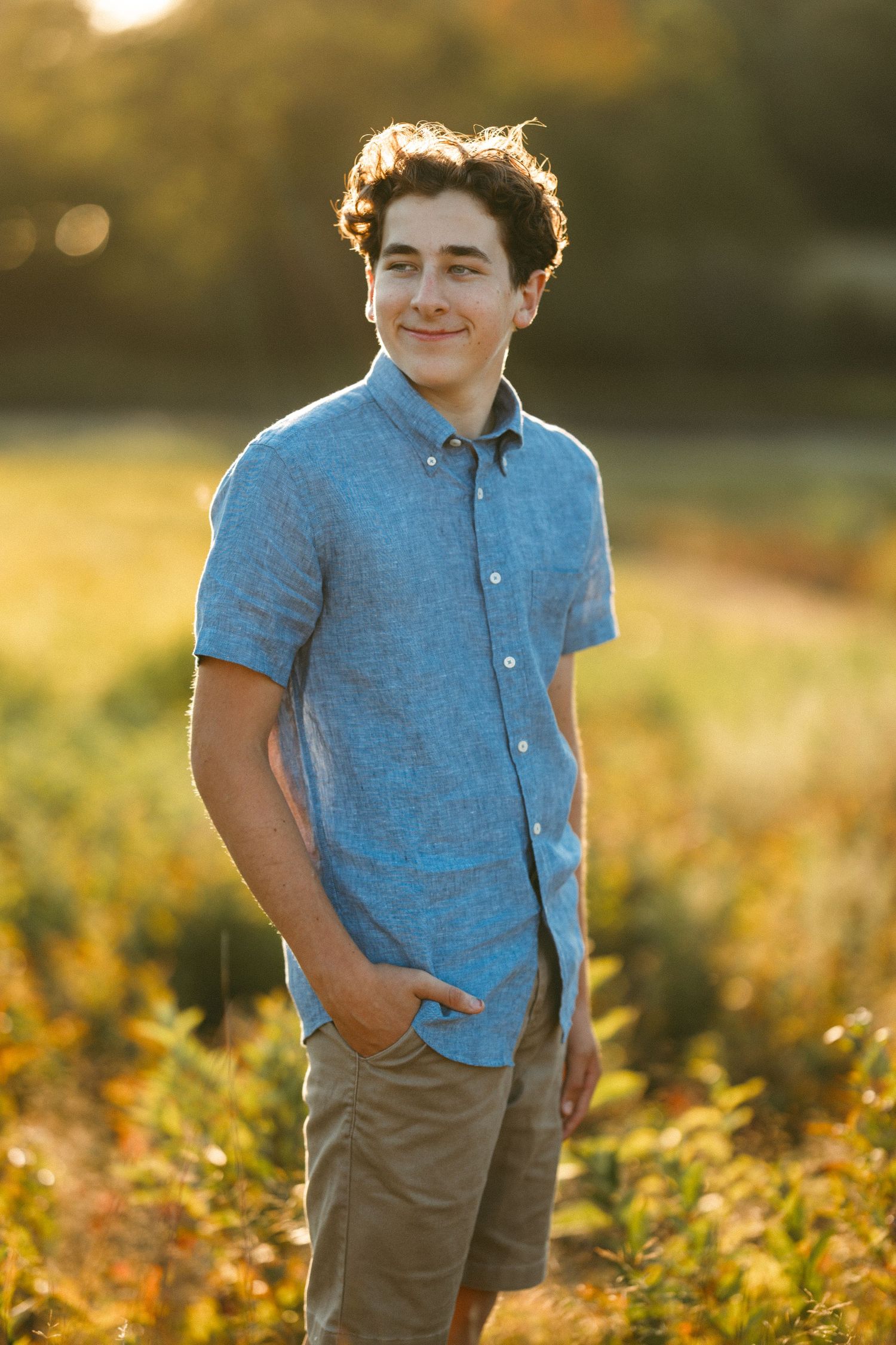 Outdoor portrait series in golden hour light showing person in blue polo and khaki pants.