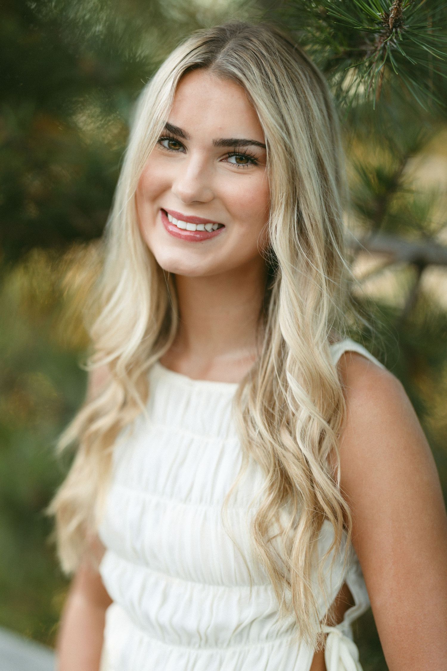 A series of outdoor portrait photos showing someone in a white sleeveless top against a natural background.