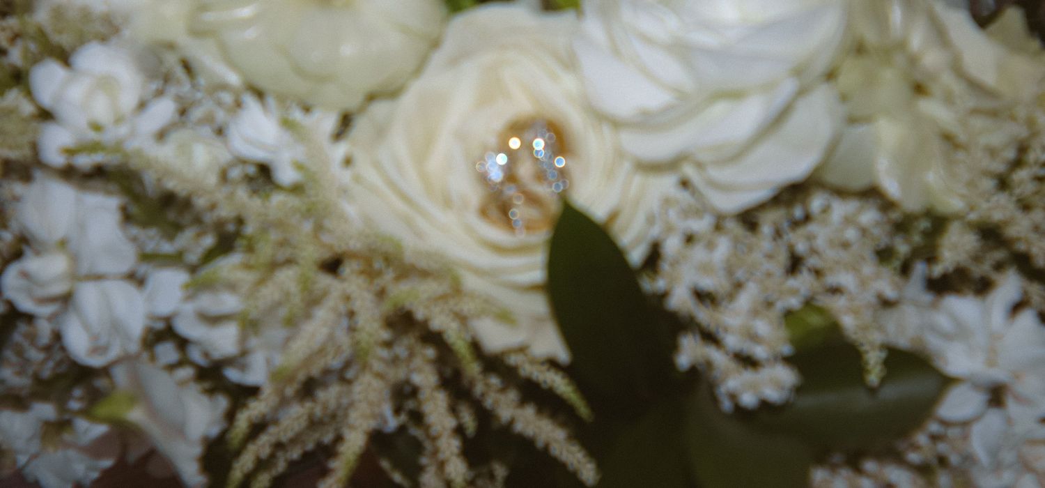 Elegant white roses and floral arrangements create a romantic wedding backdrop.