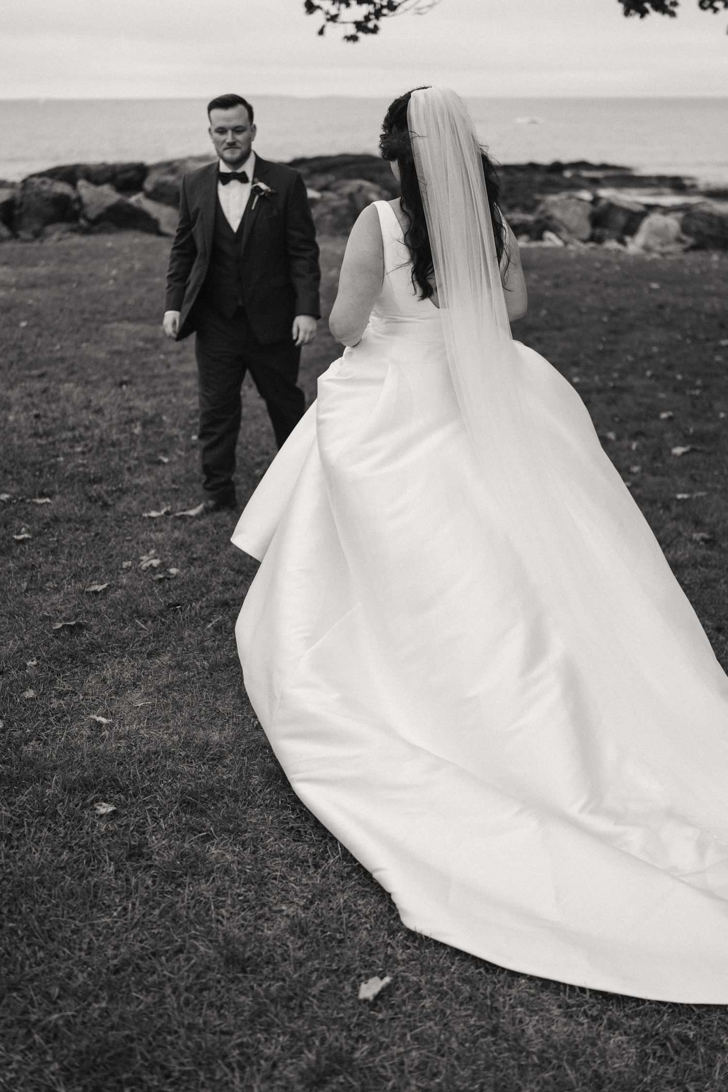A black and white wedding photo sequence showing the flowing movement of a bride's elegant white dress train in the wind.