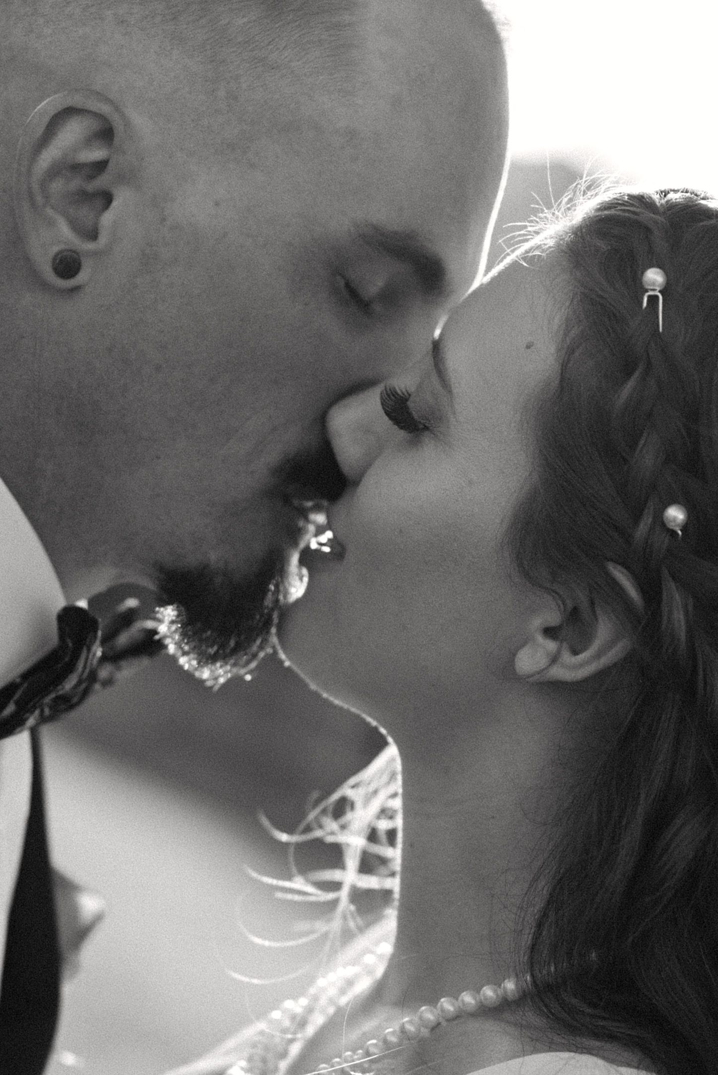 An intimate black and white wedding portrait capturing a tender moment.