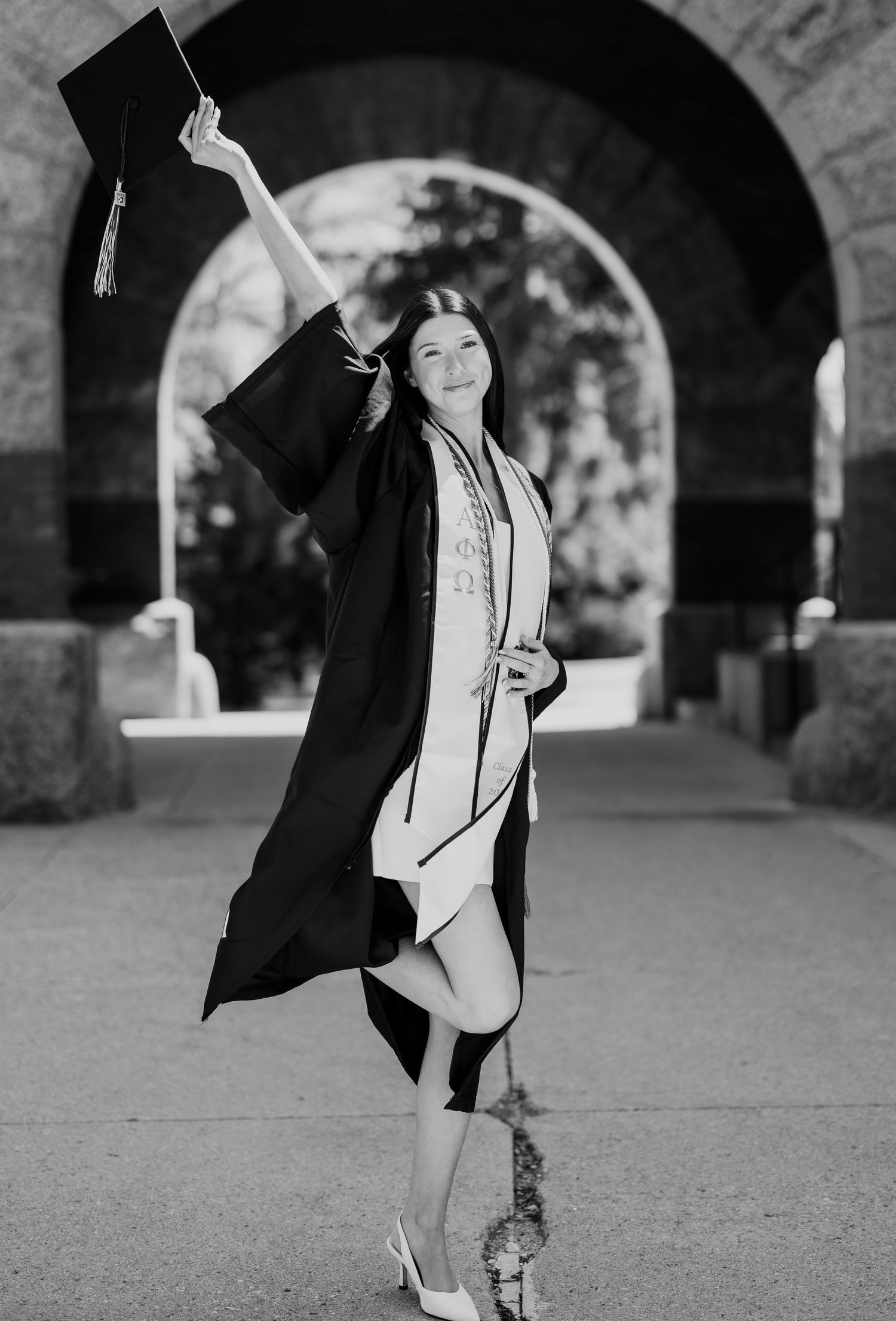 Black and white graduation photos showing celebratory poses under brick archways.