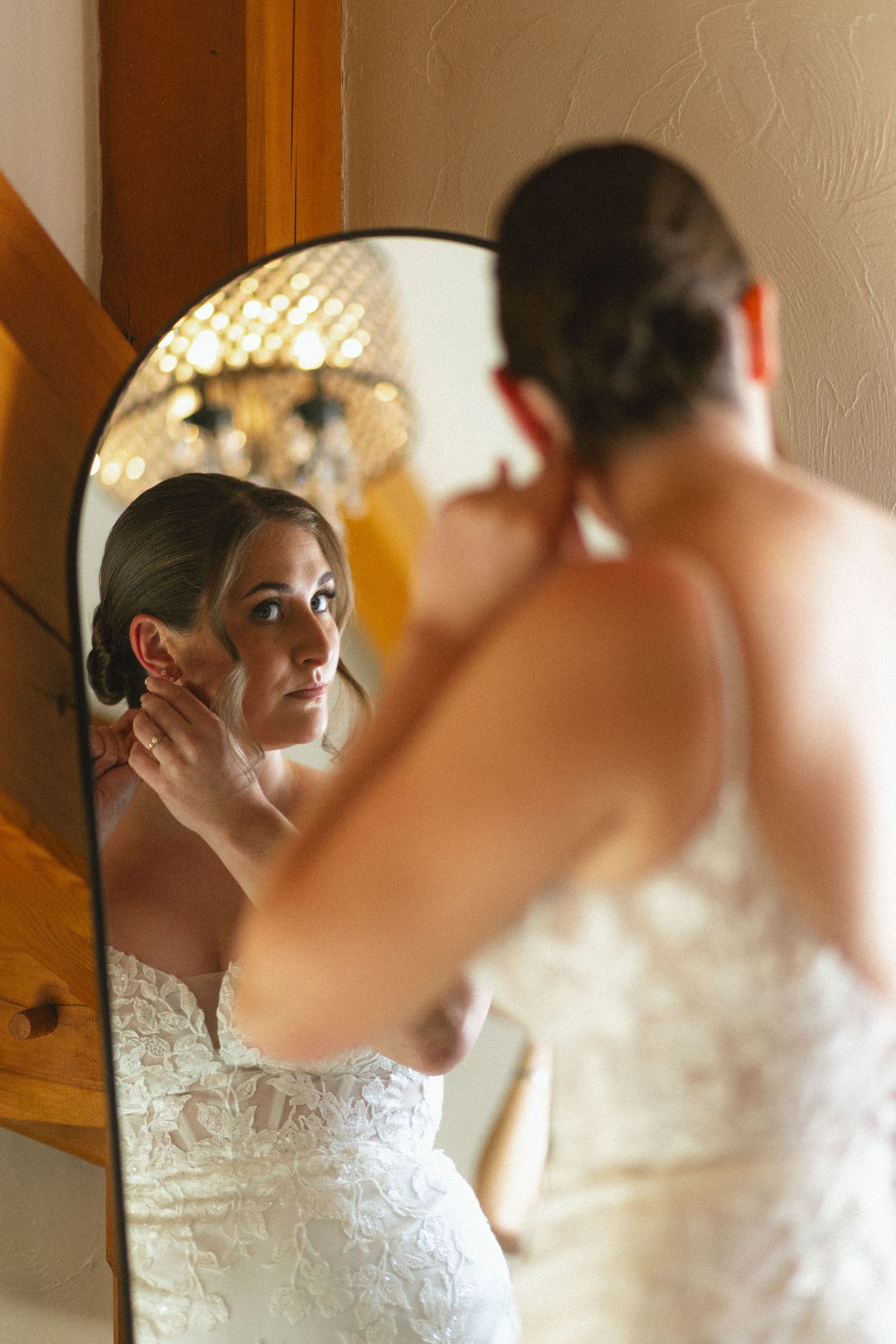 Wedding preparation scene with bridal party getting ready in elegant white dresses.