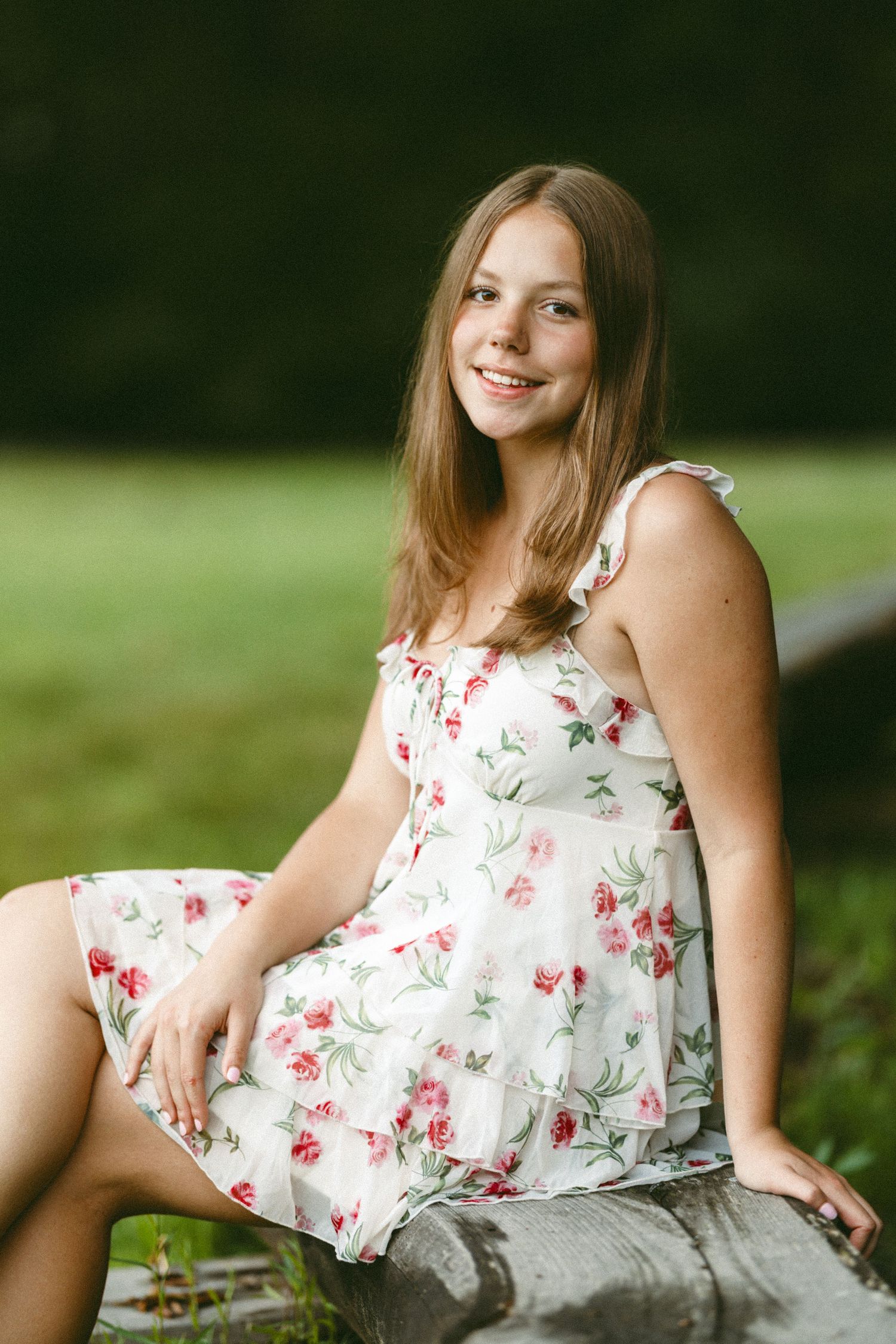 A series of outdoor photos showing someone in a floral dress relaxing on grass.