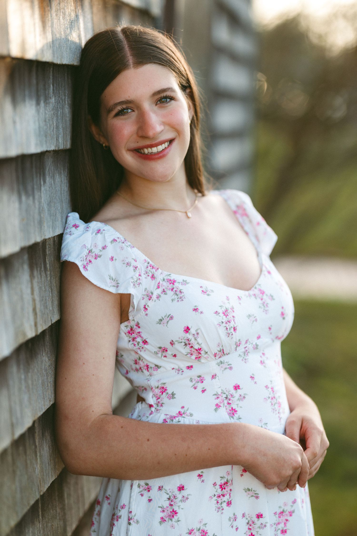 Portrait series showing person in white floral dress against rustic wooden wall.