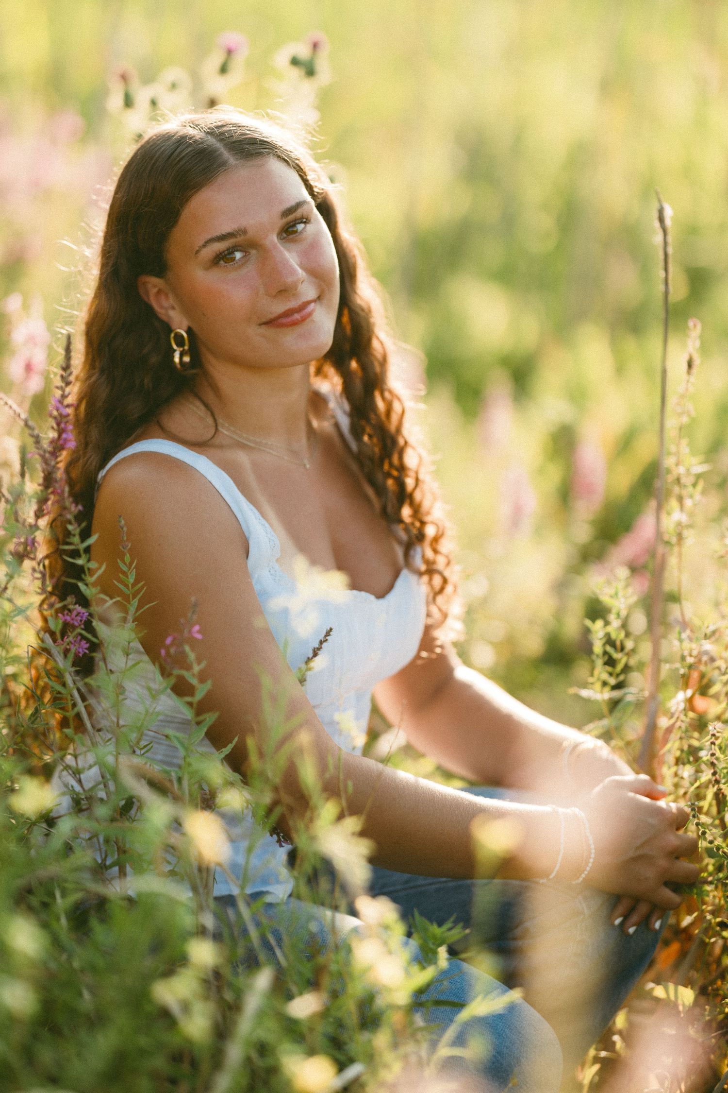 Golden hour portraits in a wildflower field with someone wearing a white tank top.