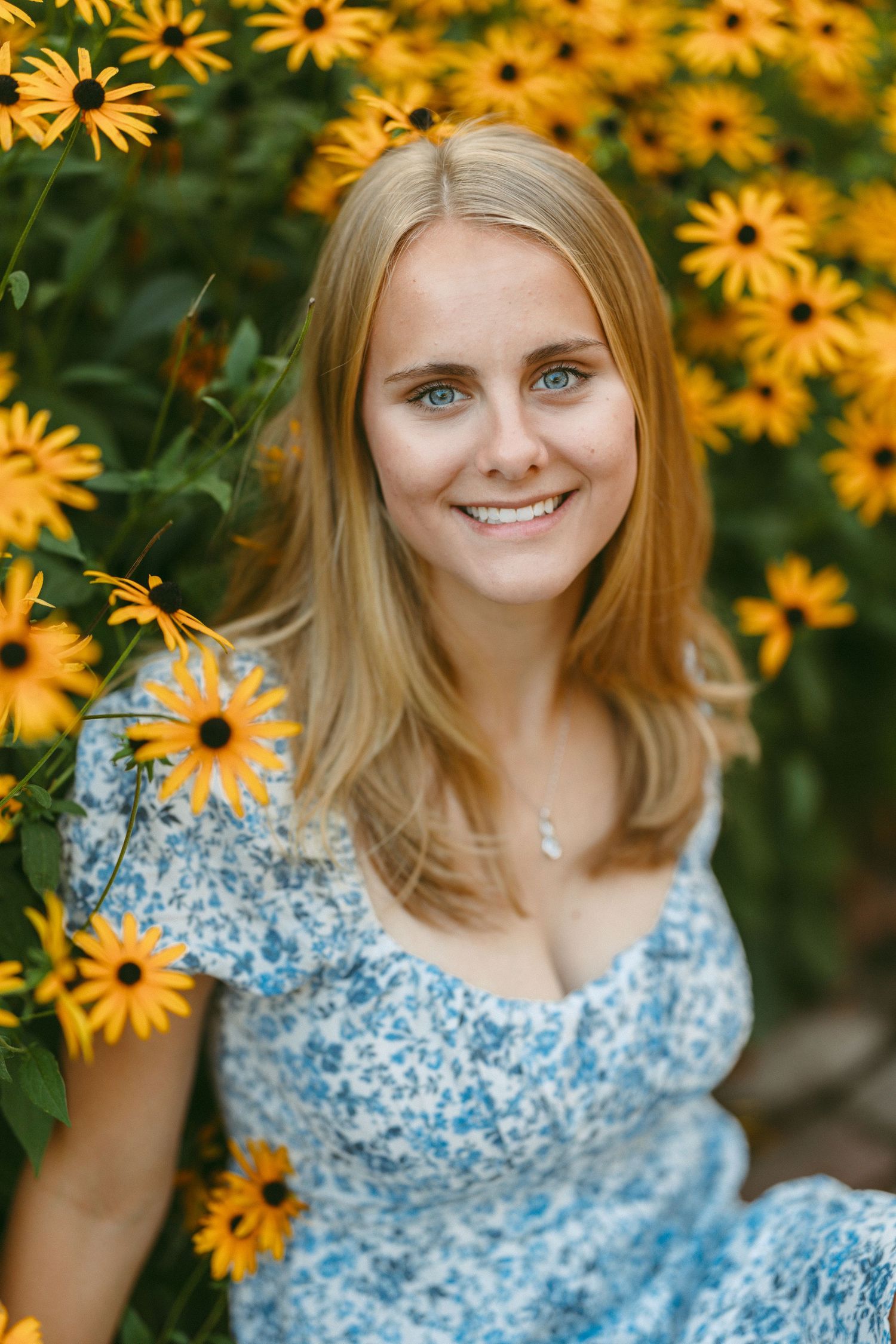 Yellow black-eyed susan flowers frame a summer portrait.