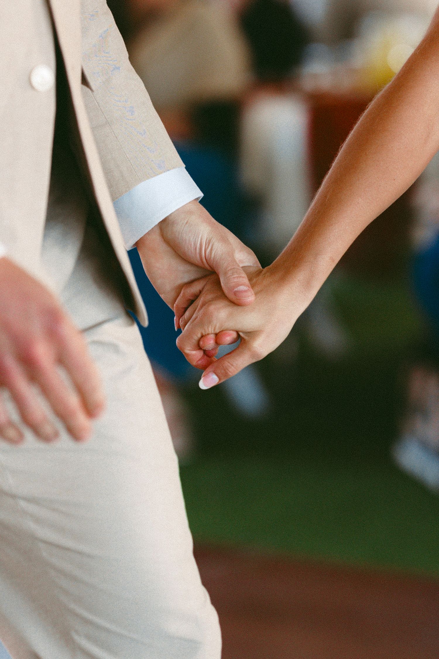 Close-up sequence showing hands holding during wedding ceremony.