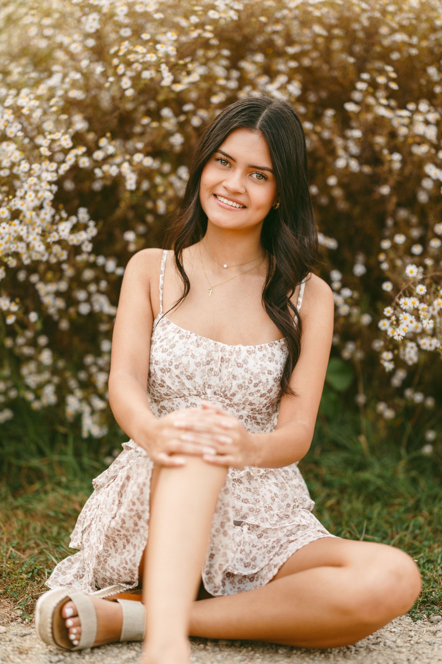 A floral sundress complements the blooming cherry blossoms in a dreamy spring photoshoot.