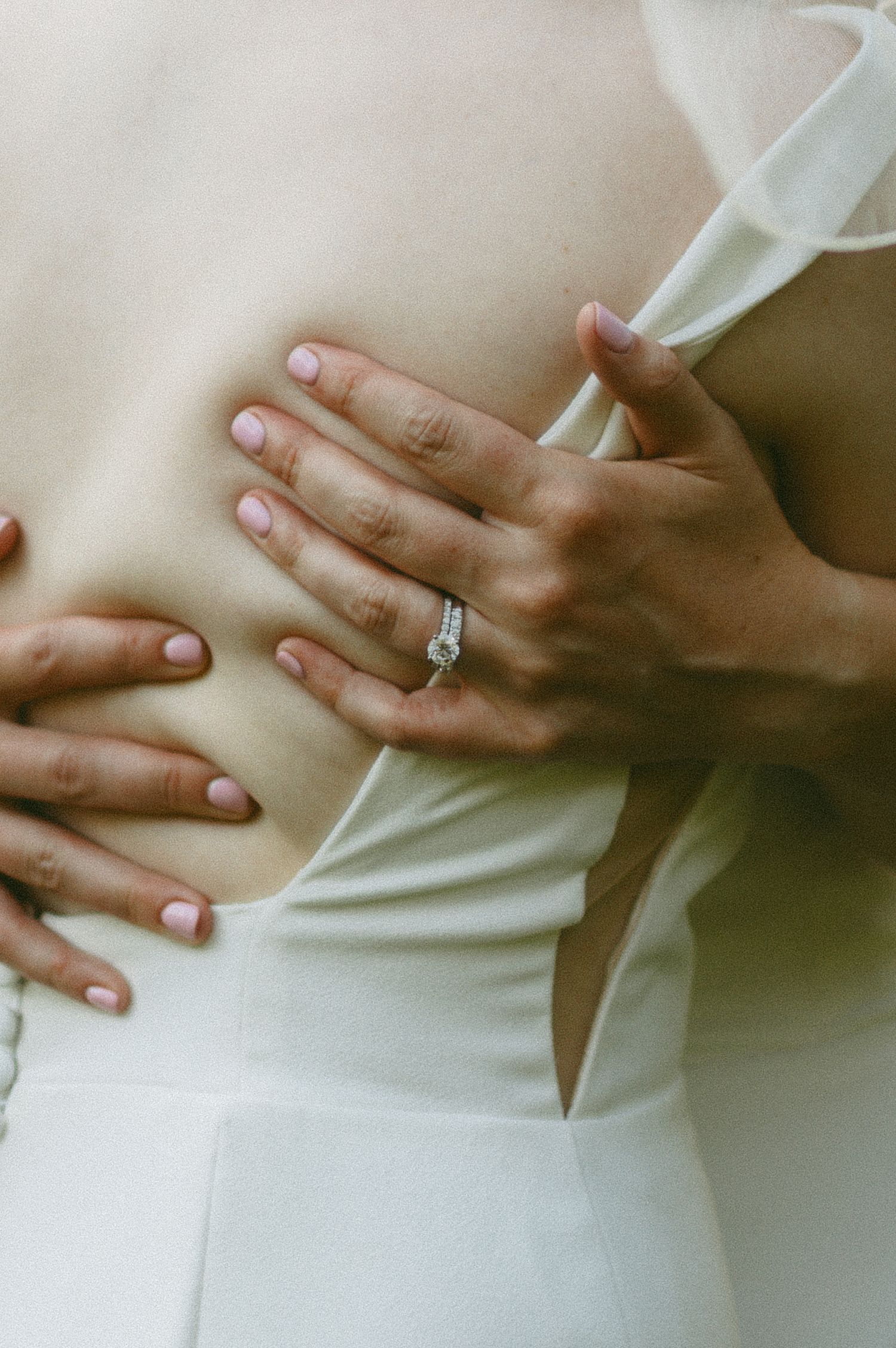 Close-up shots of hands with wedding ring against white fabric.
