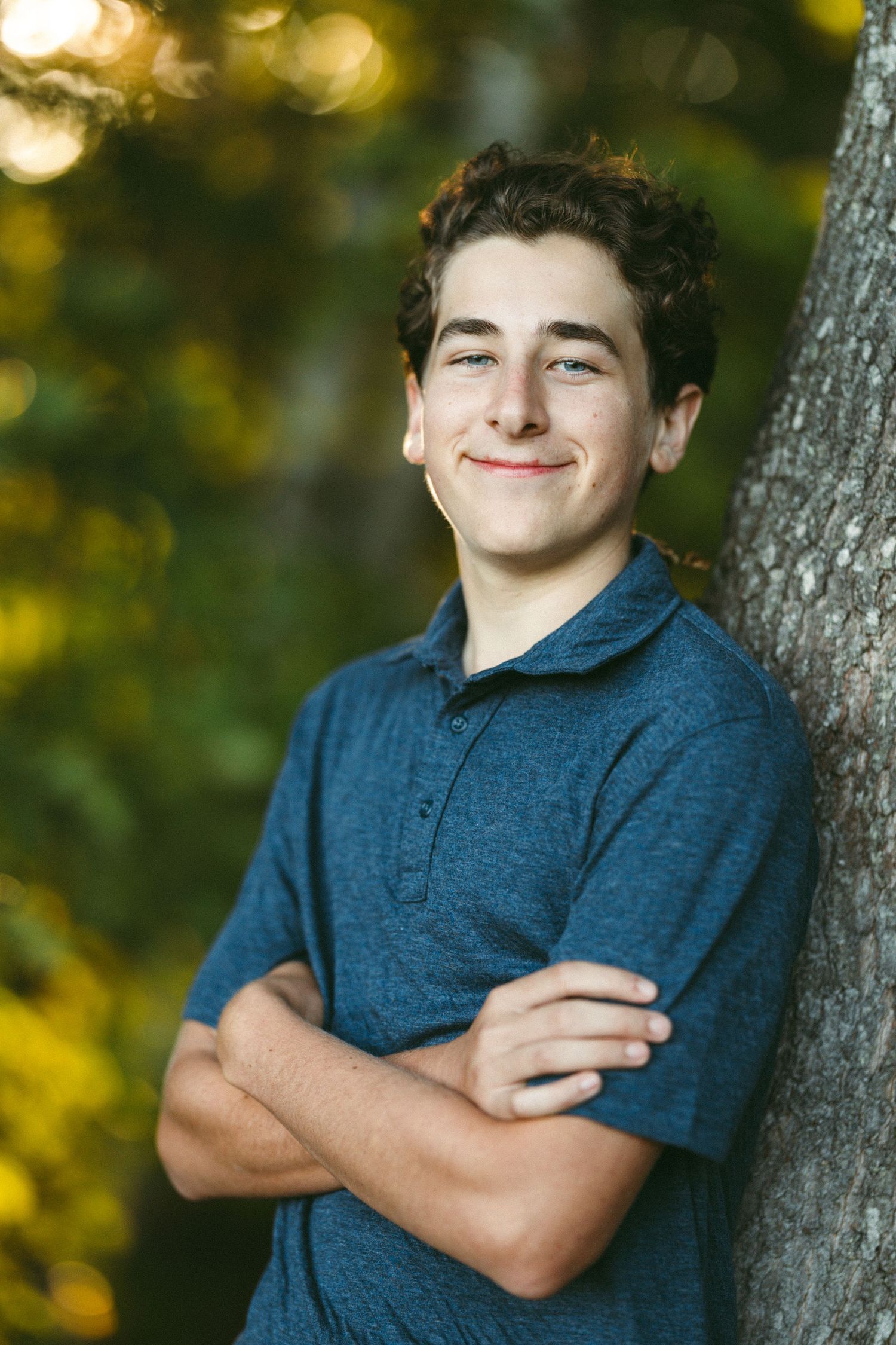 Series of casual portraits against trees showing person in blue polo shirt.