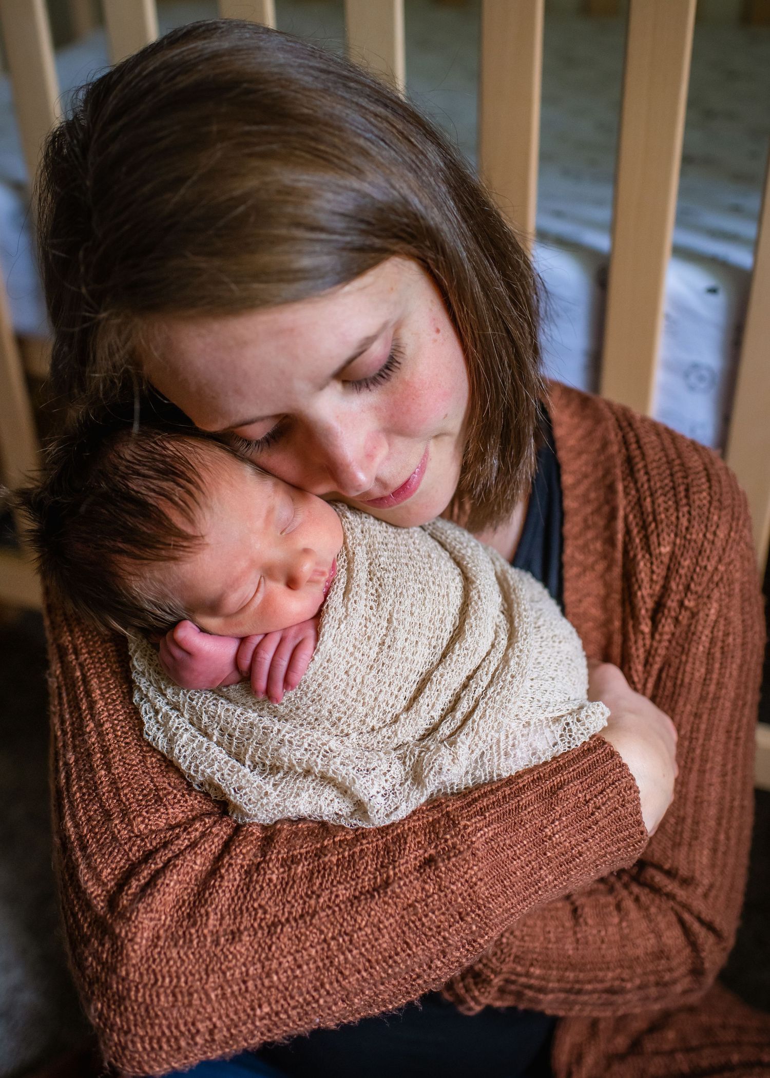 A tender moment captured in warm light shows gentle embrace and connection.