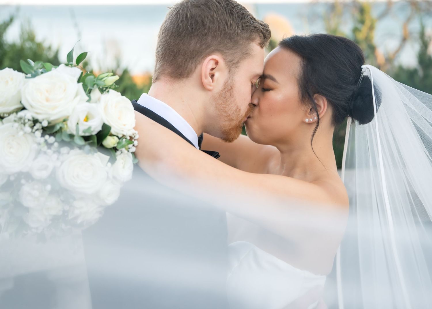 A romantic wedding photo collage showing tender moments between newlyweds with white floral decorations and a veil.