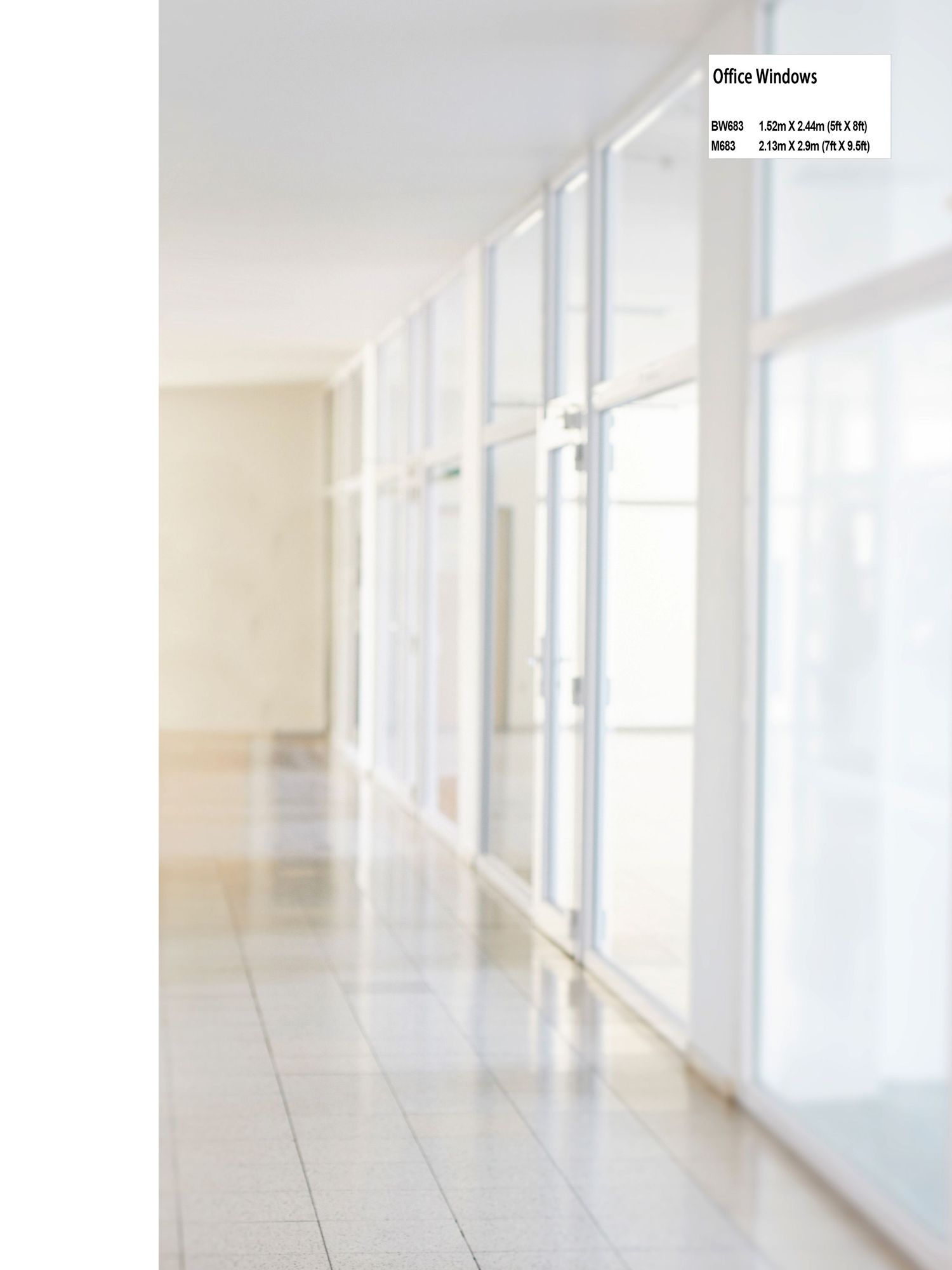 Bright white hallway with floor-to-ceiling windows creating dramatic lighting.