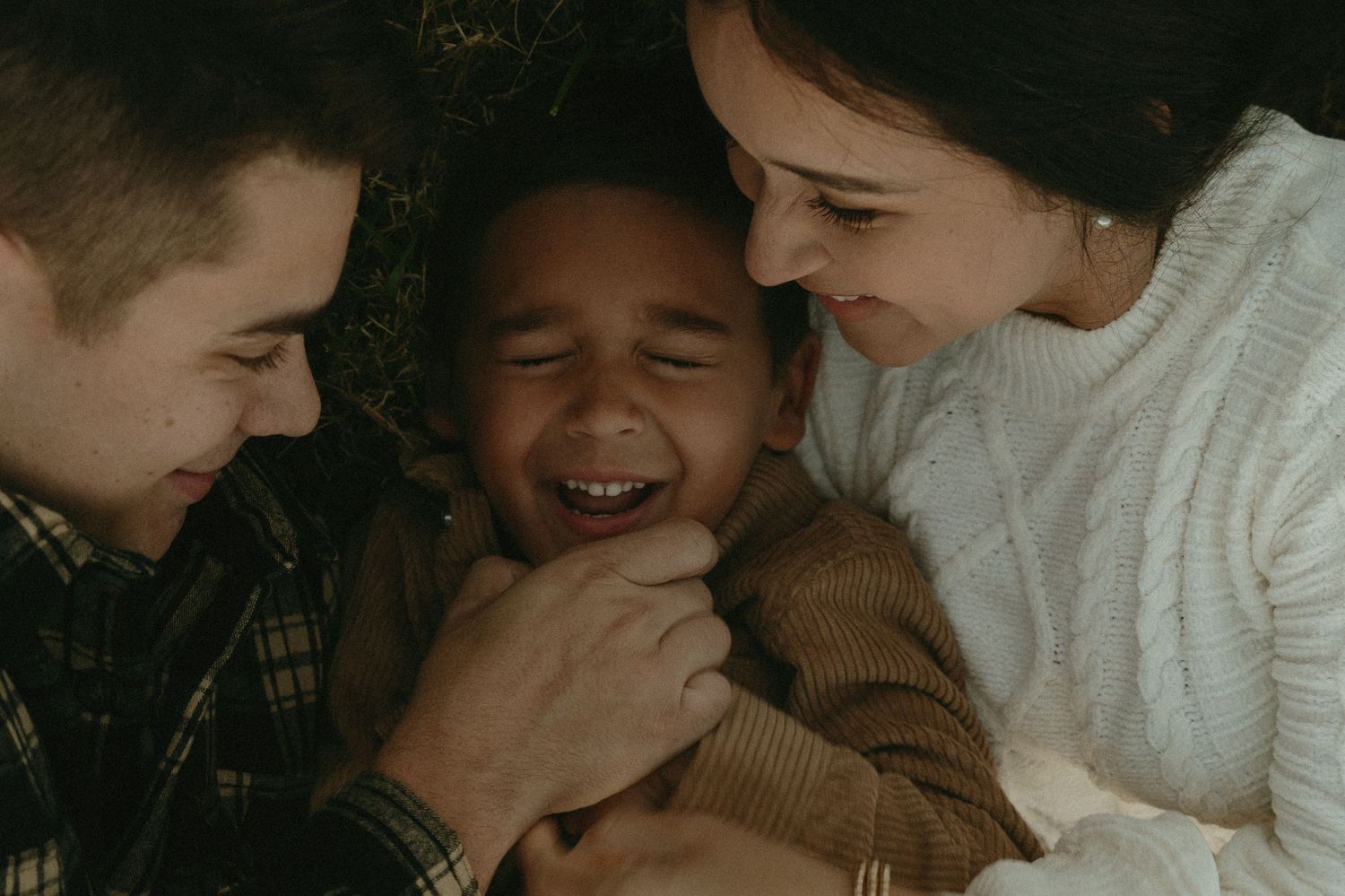 A series of candid black and white photographs showing tender family moments and laughter between loved ones.