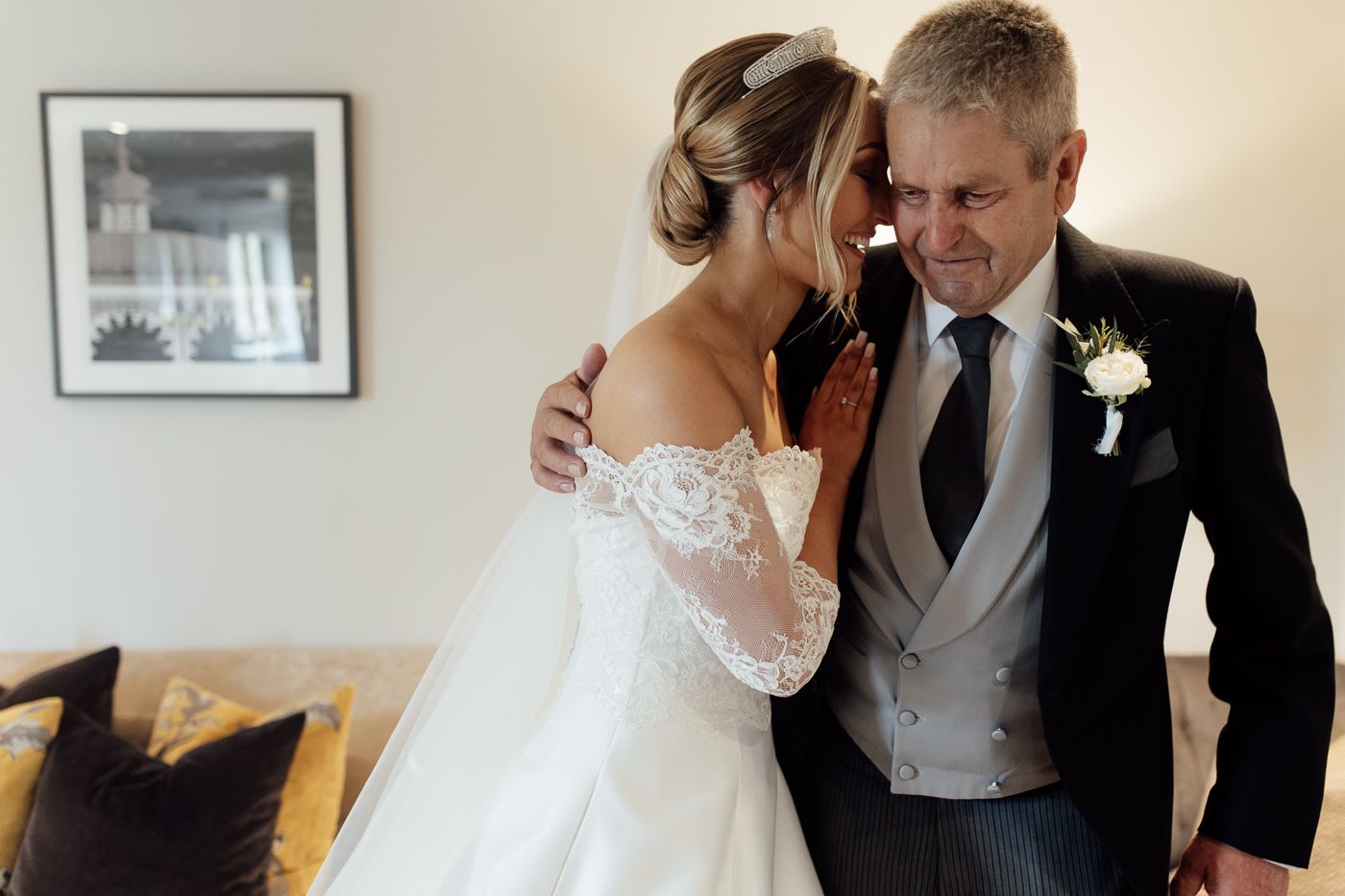 Sweet candid moment between bride and her father sharing an intimate embrace