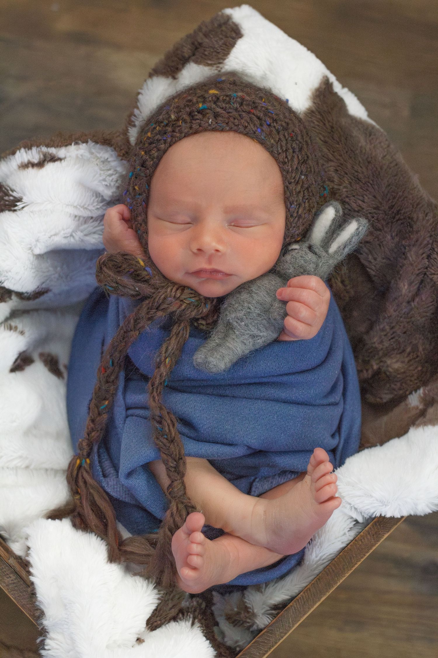 Newborn boy in denim wrap asleep in cozy pose – Dalton GA newborn photographer
