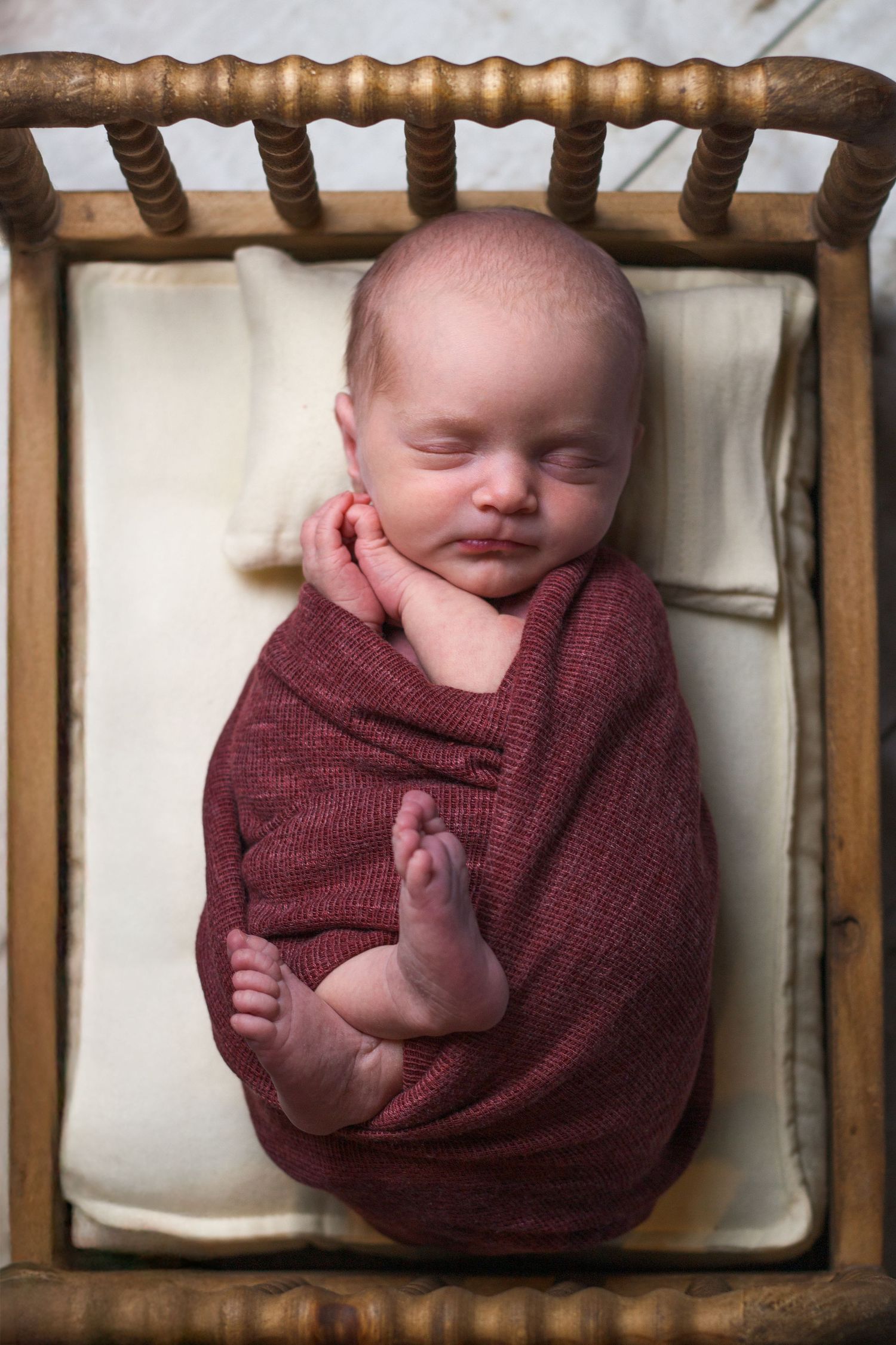 Framed newborn portrait with burgundy tones – Dalton GA newborn photography.
