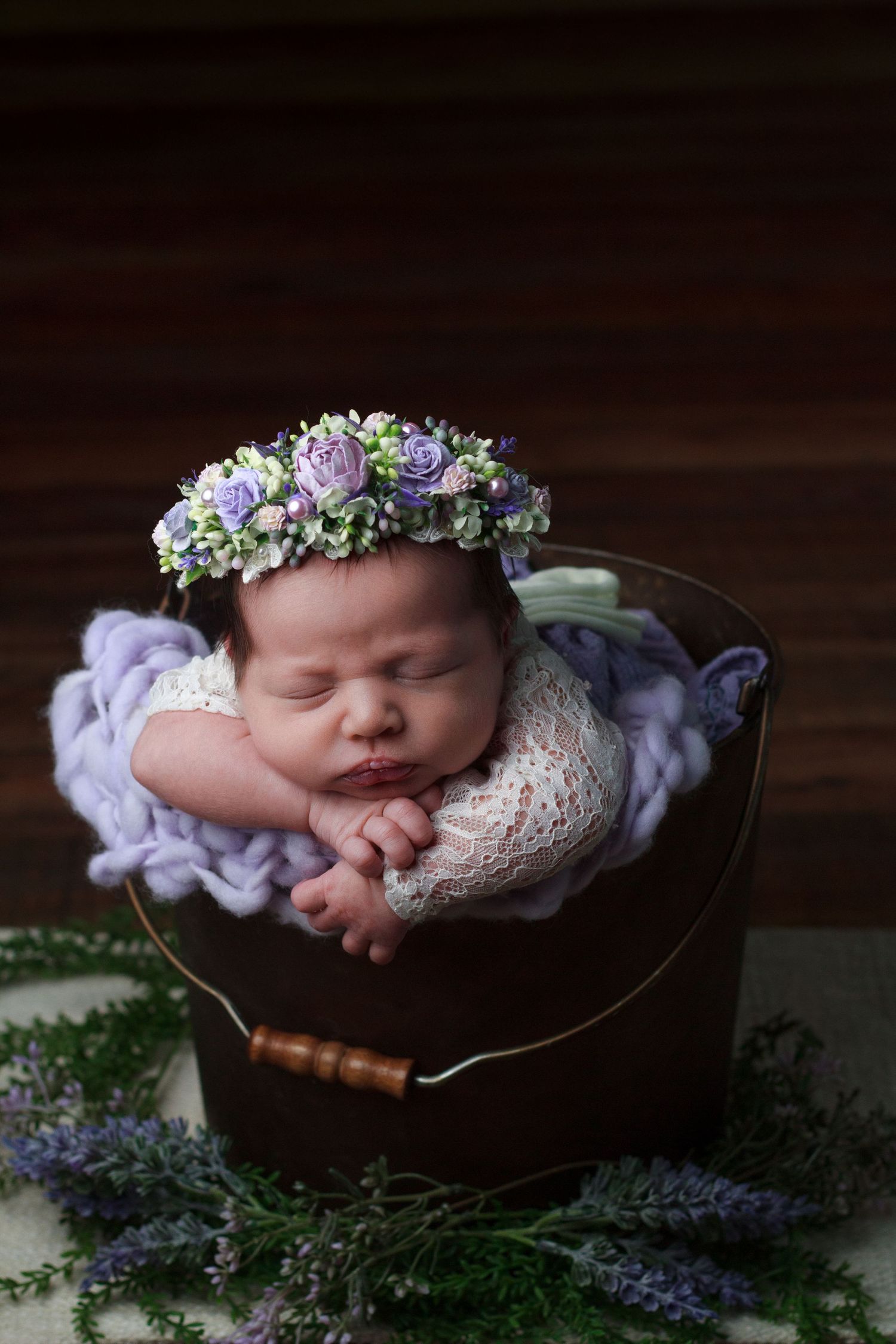 Newborn baby girl wrapped in vintage lavender  inside a bucket during a Dalton, GA newborn photography session