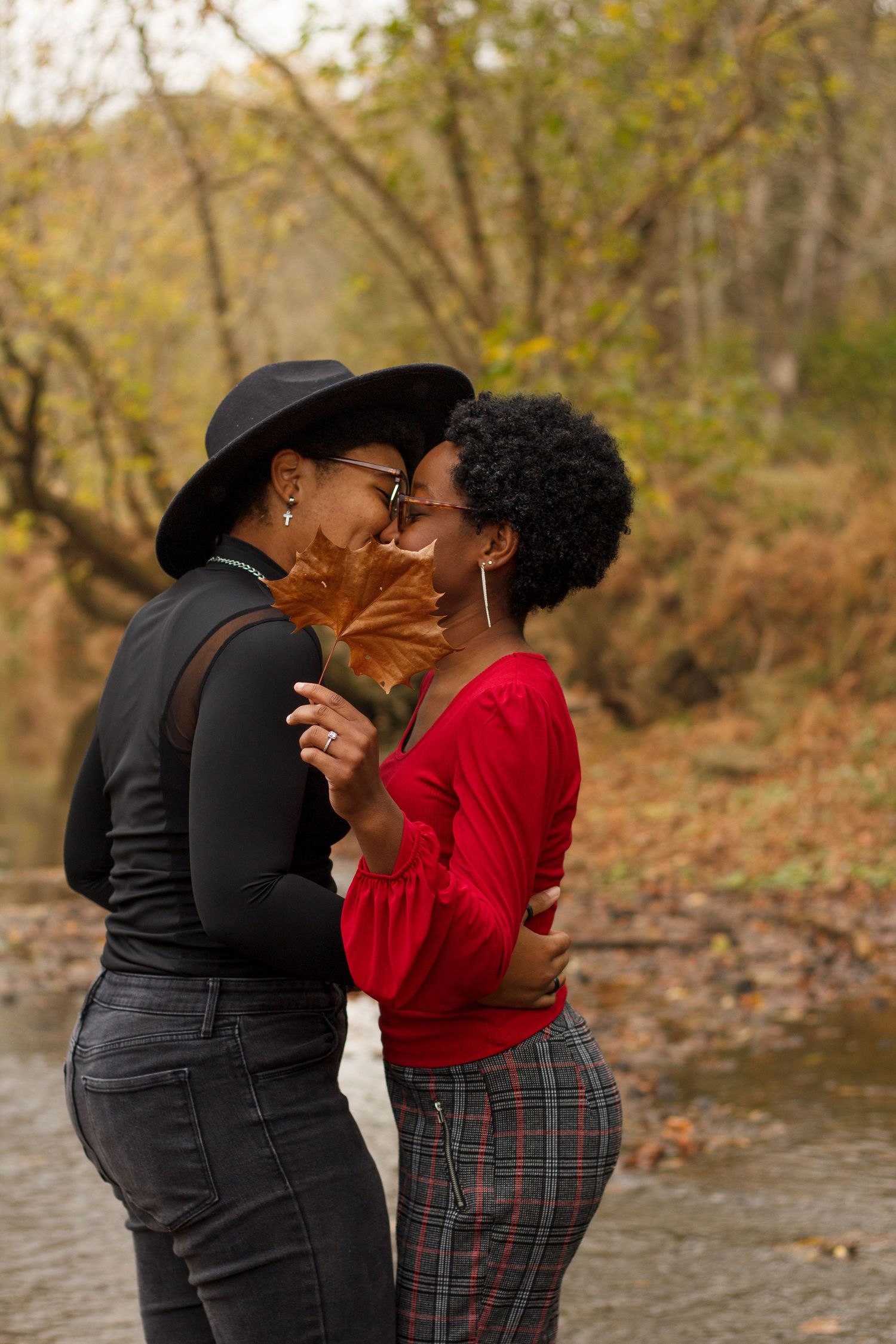 Couple kissing with a large fall leaf blocking view - LGBTQ+ friendly Chattanooga TN Photographer