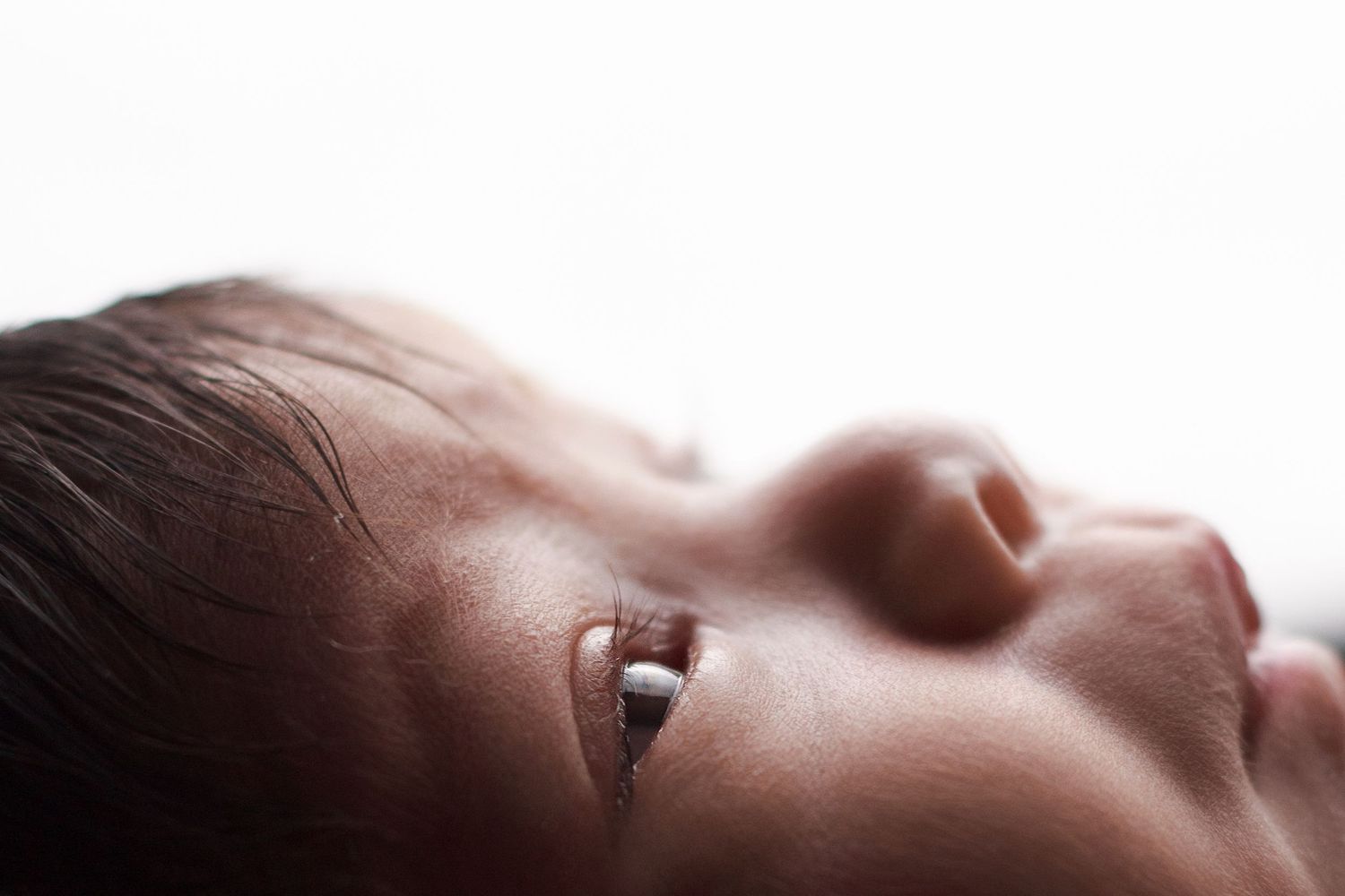 Close up of awake baby during a cozy in‑home newborn photography session in Dalton, Georgia