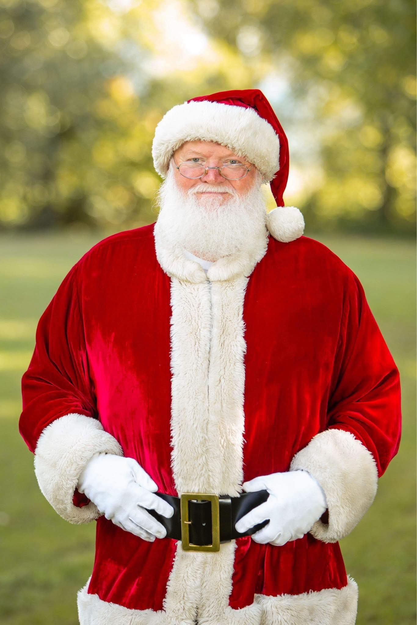 Santa Claus standing outdoors during a Christmas photography session in Dalton, Georgia.