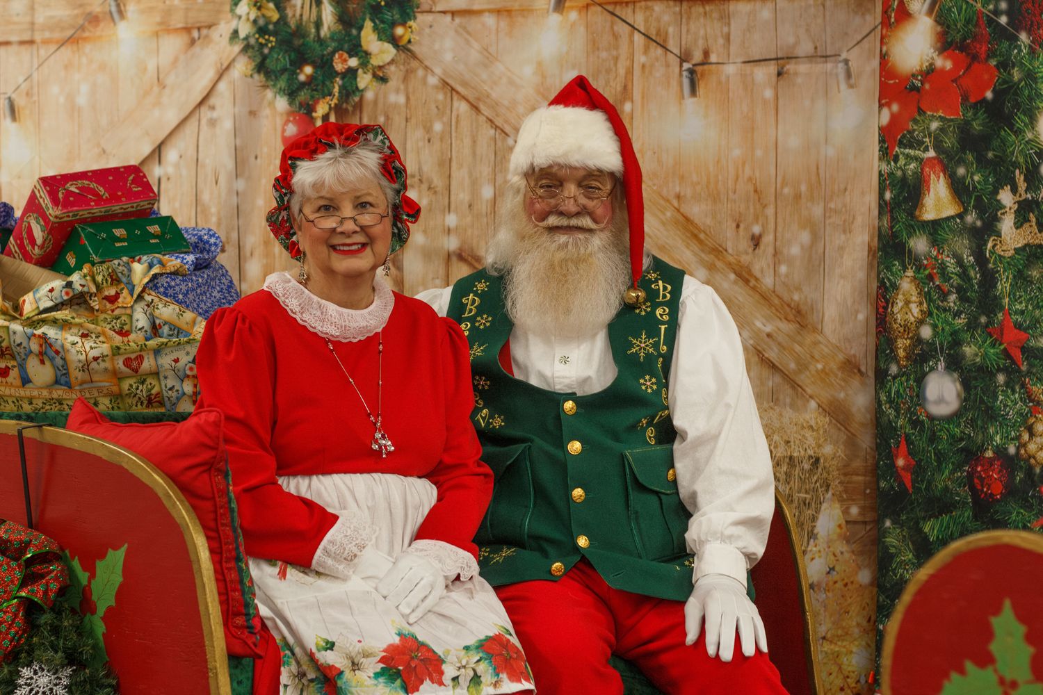 Santa Claus and Mrs. Claus sitting together during a Christmas mini photography session in Dalton, Georgia.