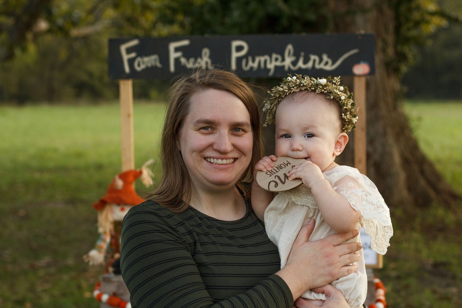 Northwest Georgia family photography Tiffany  Vick posing with a baby during their outdoor milestone session.