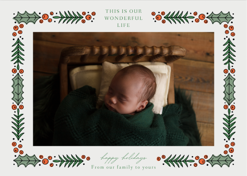 Newborn baby boy wrapped in emerald green sleeping on a spindle bed